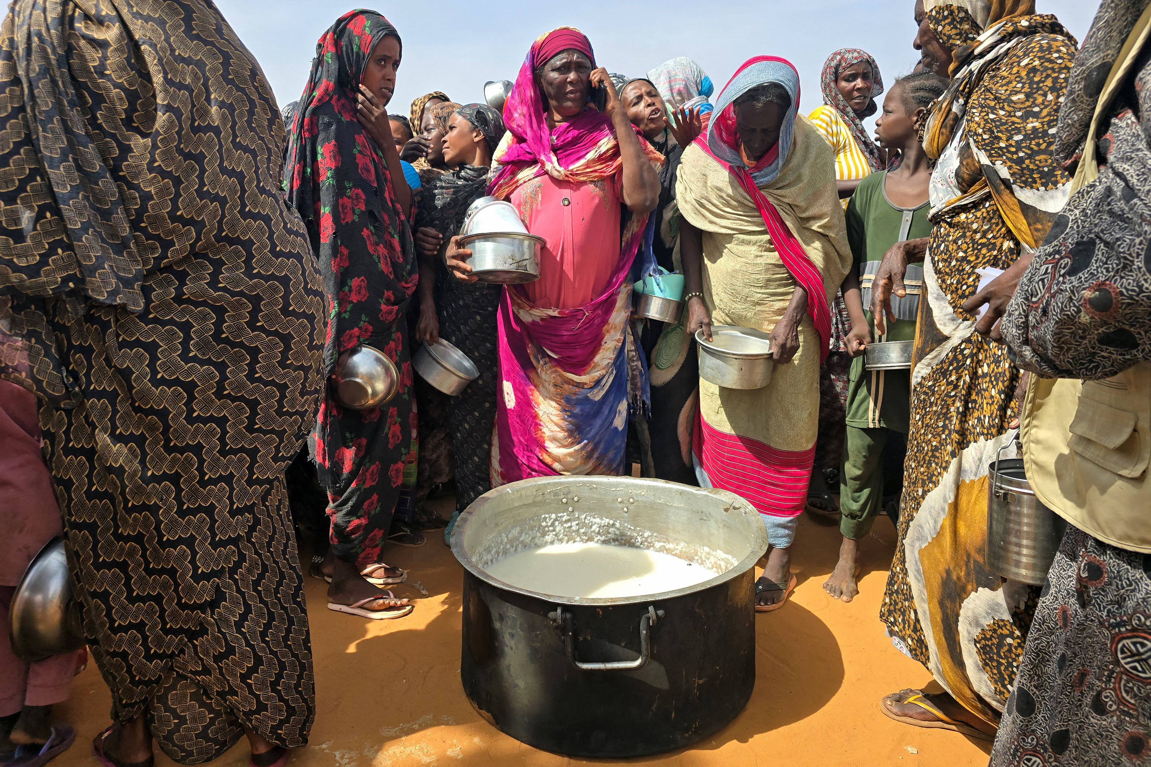 Sudanese women gather for a hot meal in al-Rahmaniyah camp for displaced people, near the city of El-Obeid in the southern Kordofan region on July 7, 2026.