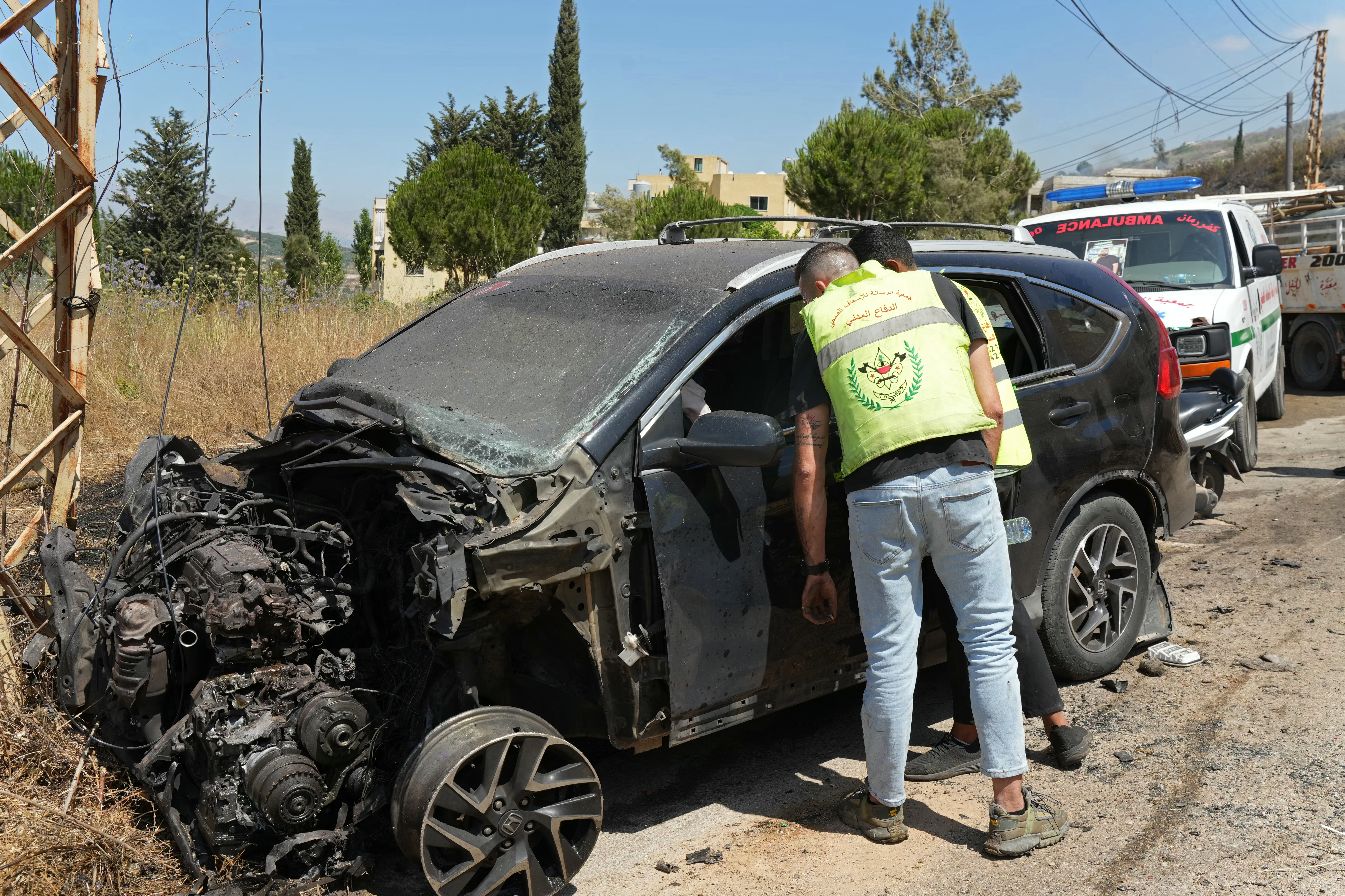 First responders inspect a vehicle that was reportedly damaged by an Israeli strike in the southern Lebanese village of Kfar Roummane on July 10, 2026.