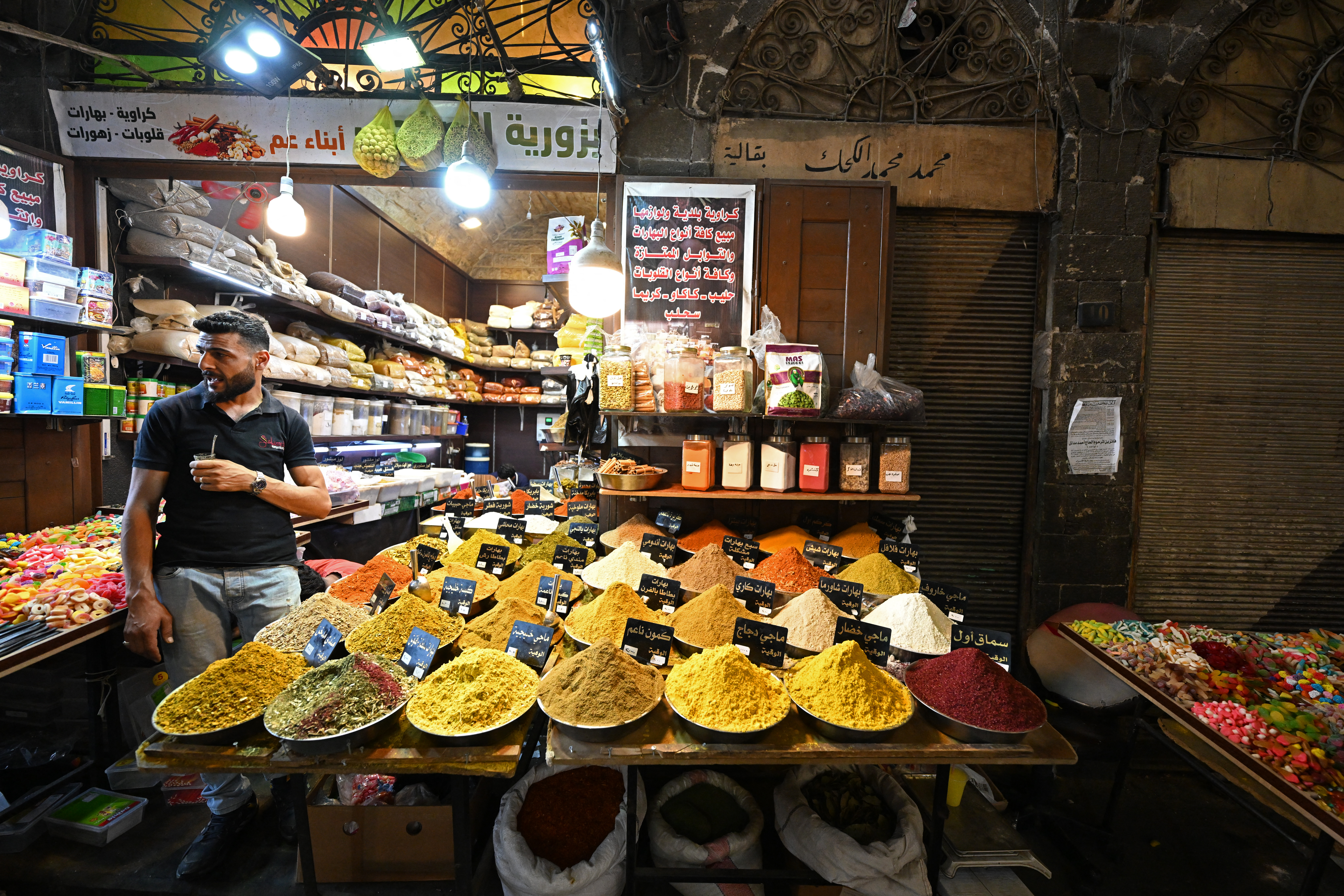 A shopkeeper waits for customers in an old market near the Umayyad Mosque in Damascus on July 9, 2026.
