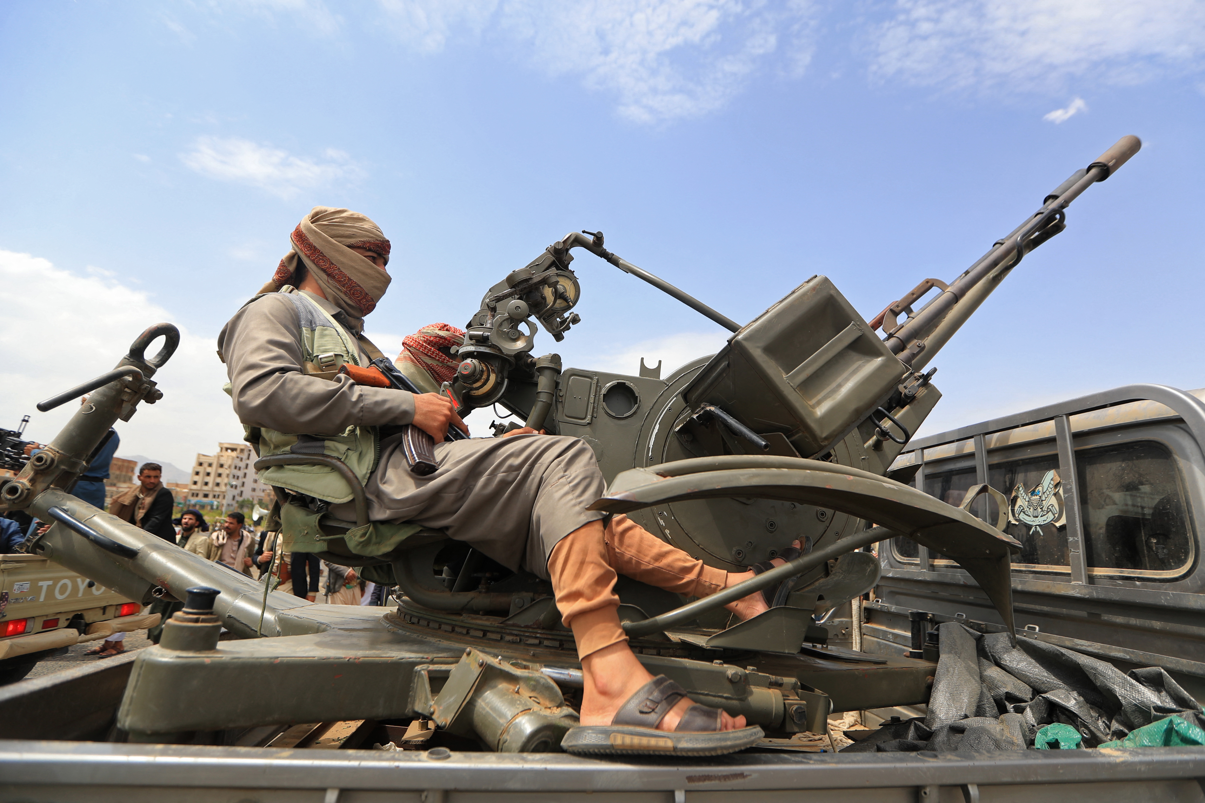 A Yemeni gunman brandishes his weapon during a rally to recruit more fighters in Sanaa on July 6, 2026. (Photo by Mohammed HUWAIS / AFP)