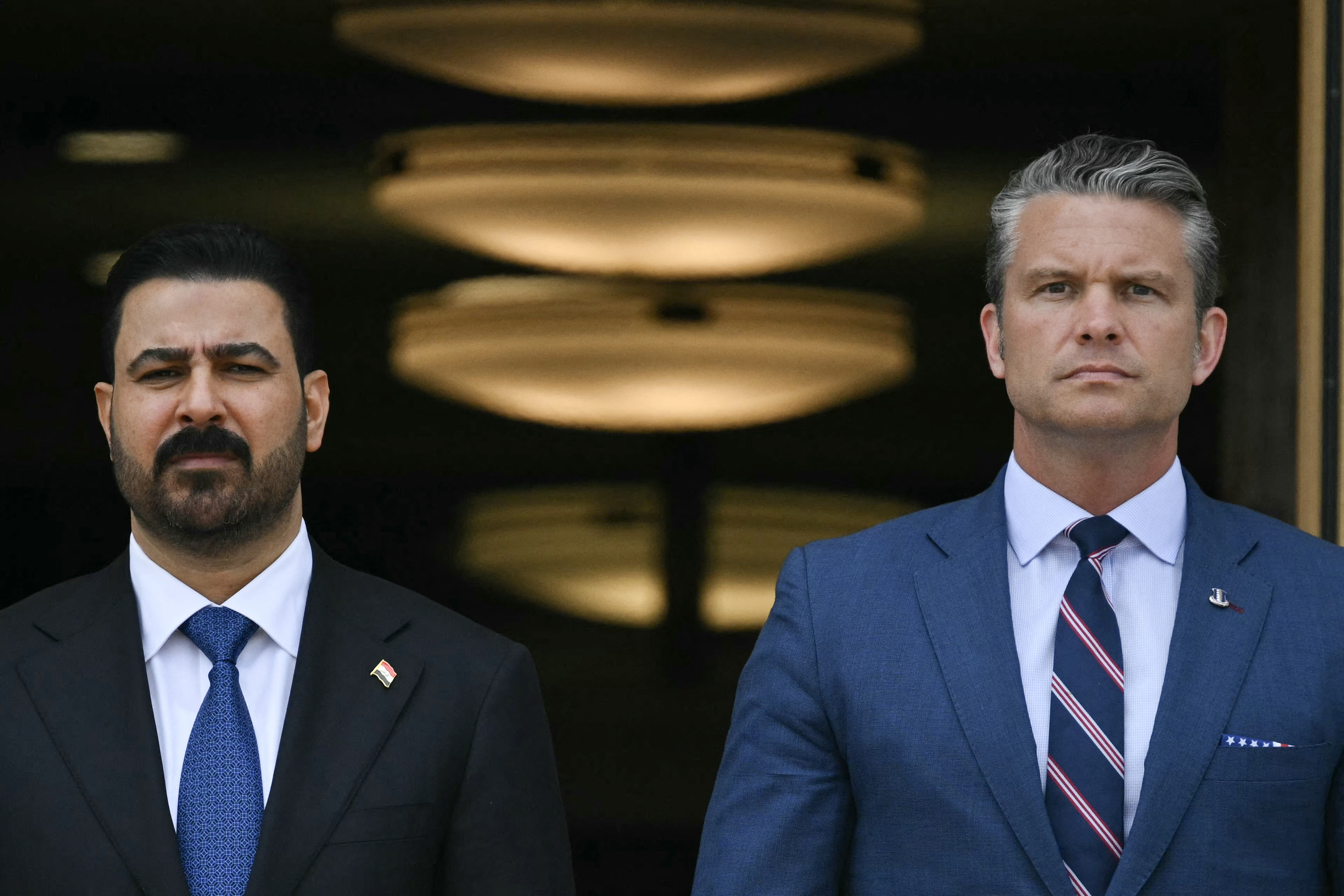 US Defense Secretary Pete Hegseth greets Iraqi Prime Minister Ali al-Zaidi (L) during an arrival ceremony at the Pentagon in Washington, DC, on July 14, 2026. (Photo by Drew ANGERER / AFP)