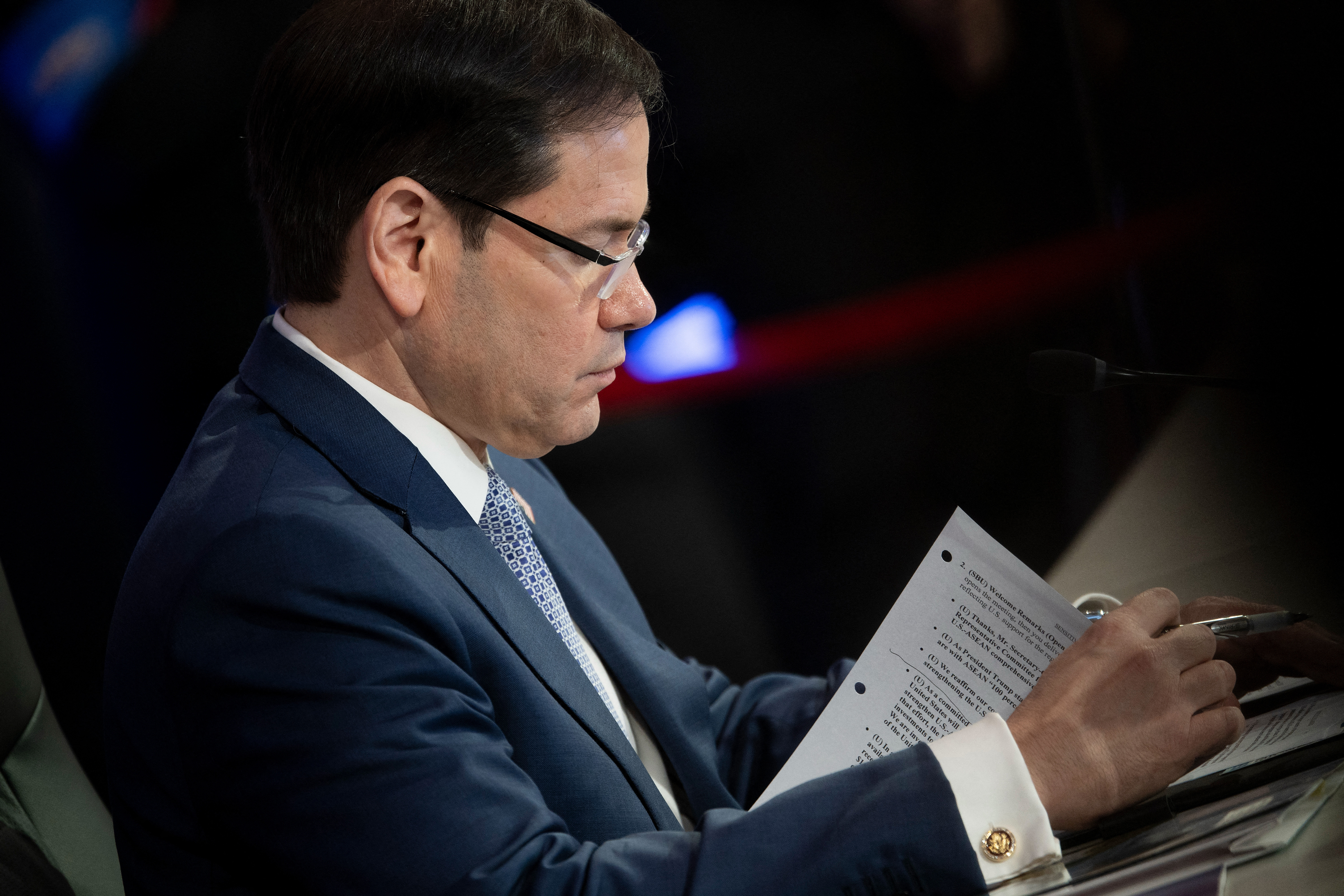 Marco Rubio looks at documents
