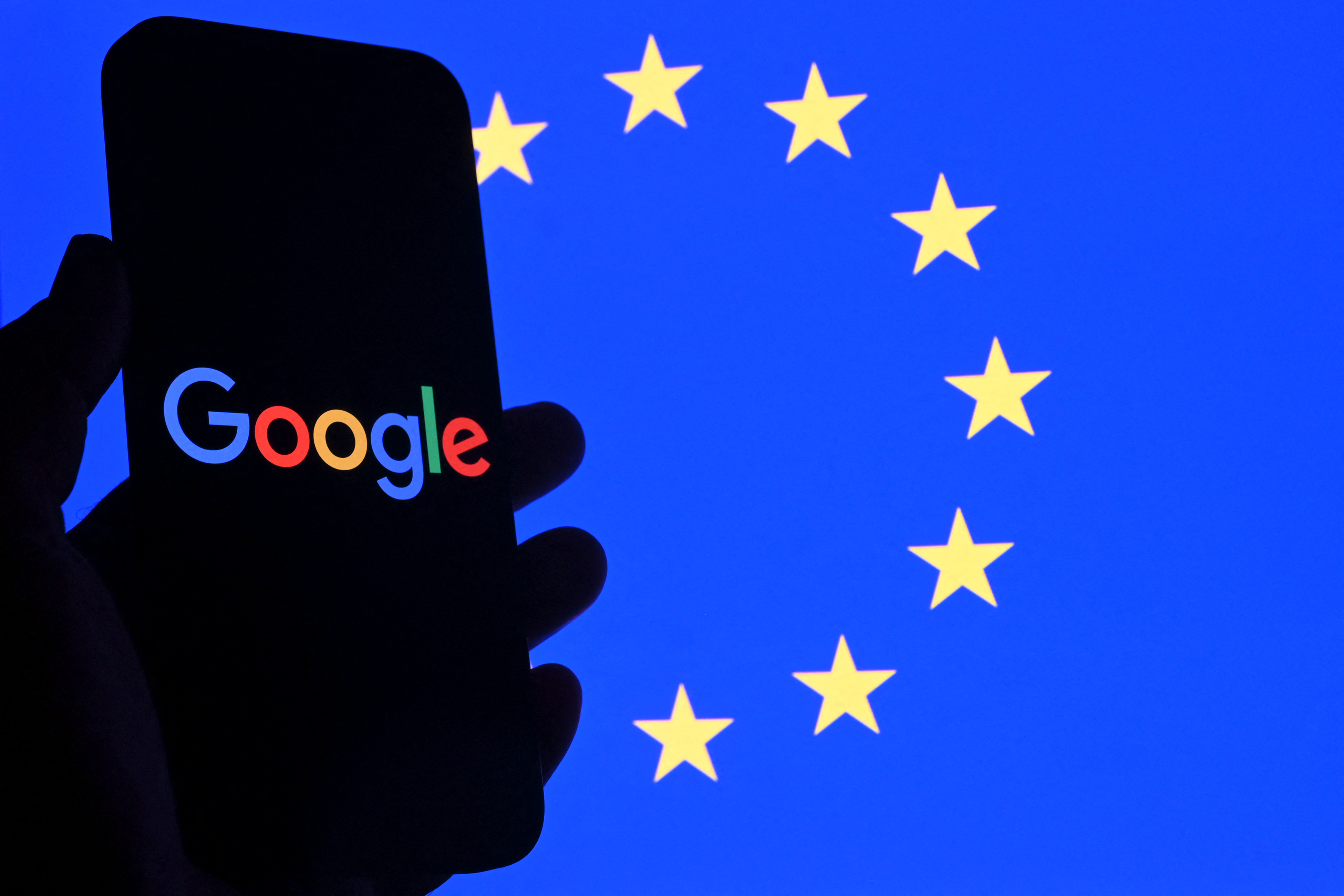 (FILES) This illustration photograph shows the logo of Google displayed on a smartphone in front of an European Union flag in Brussels on September 29, 2025.