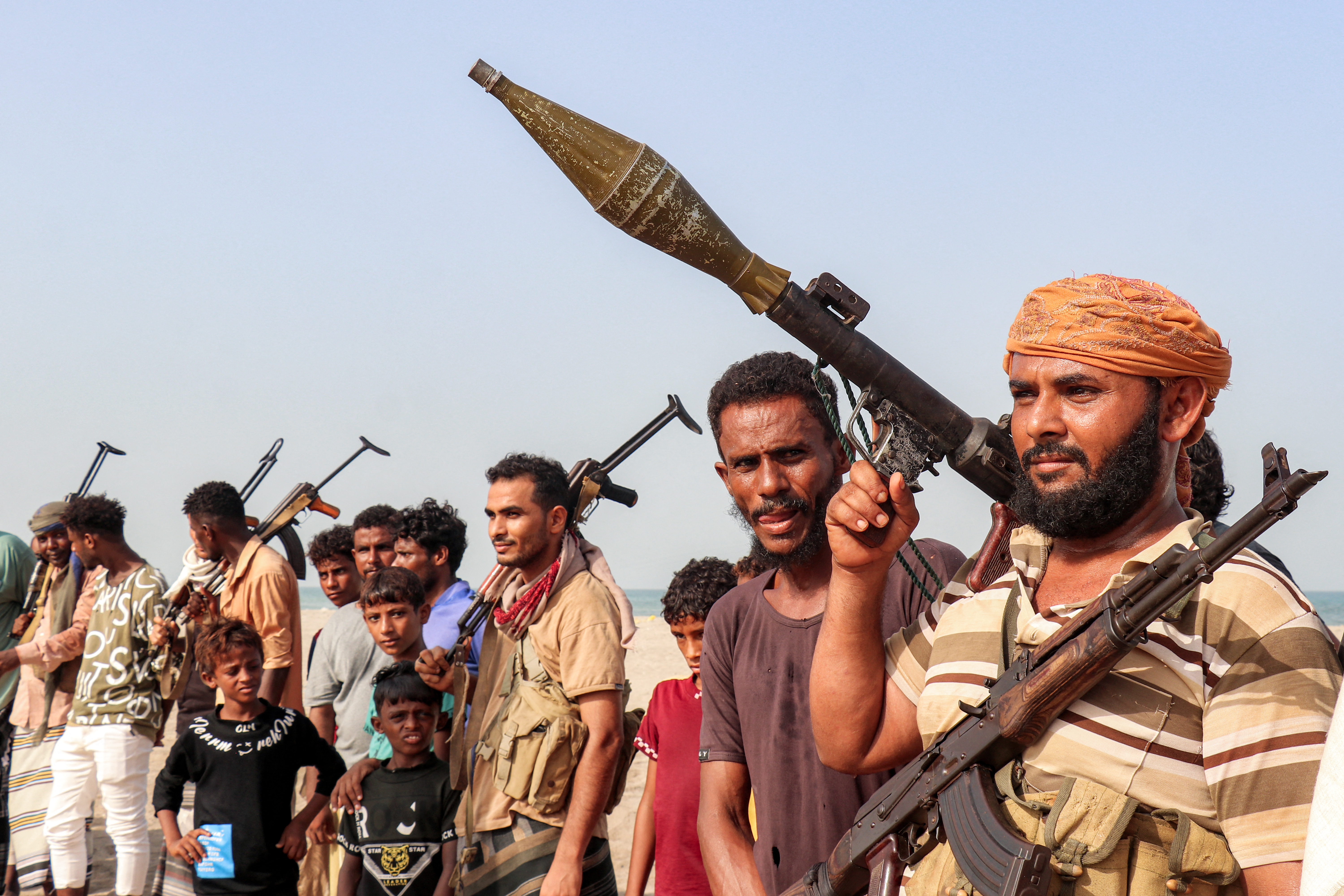 TOPSHOT - Fighters supporting the Aden-based internationally-recognised Yemeni government gather during a vigil along the Red Sea shore in Khokha, in Yemen's western Hodeidah province on July 20, 2026, calling for a resumption of hostilities with the Huthi group currently controlling the capital Sanaa.