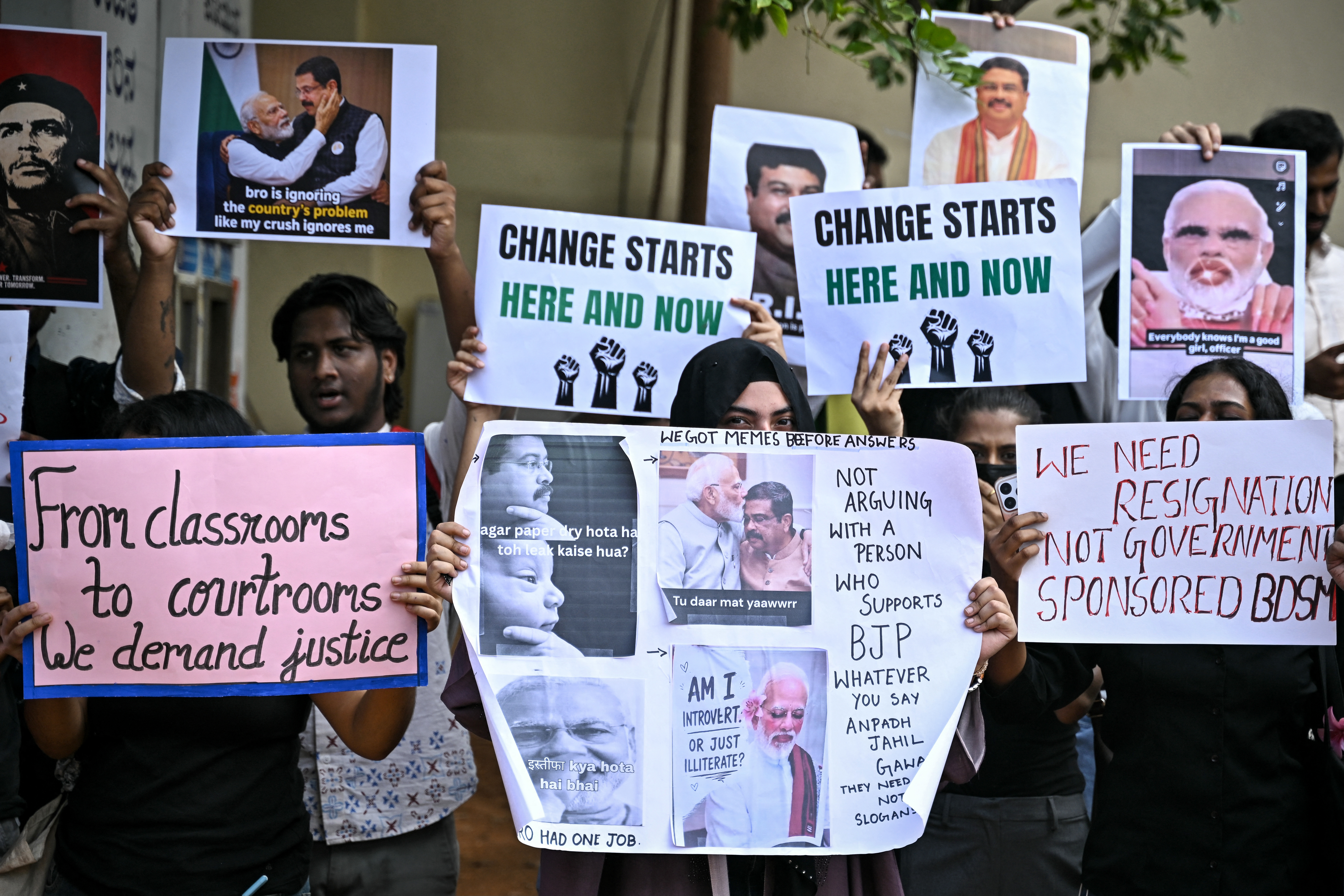 Demonstrators hold placards during a protest at Freedom Park in Bengaluru on July 24, 2026 in solidarity with the ongoing agitation at New Delhi’s Jantar Mantar demanding the resignation of India’s Education Minister Dharmendra Pradhan over alleged irregularities in the National Eligibility cum Entrance Test (NEET).