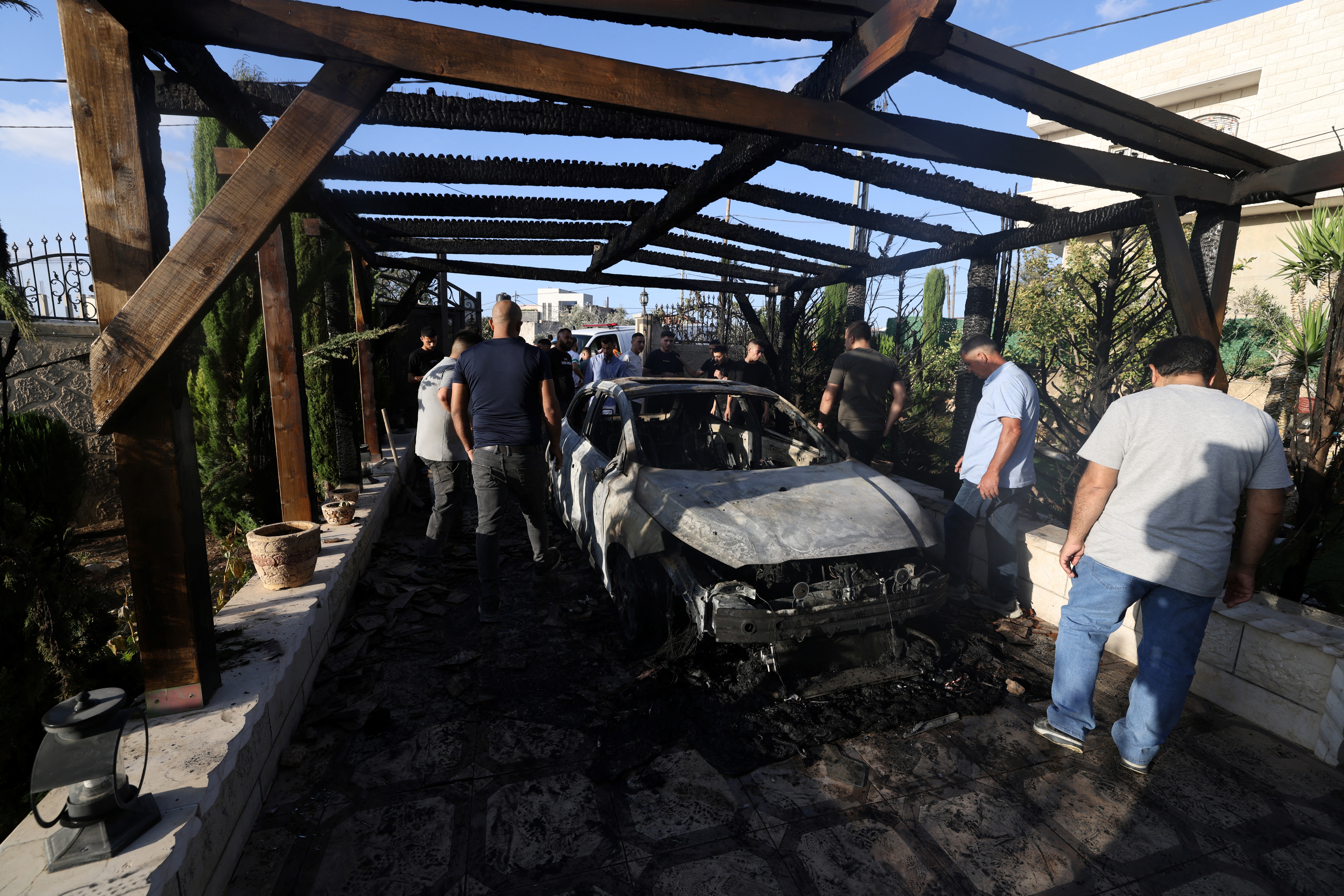 EDITORS NOTE: Graphic content / Palestinian residents look at their destroyed vehicle torched along with their home in an attack reportedly by Israeli settlers in the Palestinian village of Sarra, west of the city of Nablus in the Israeli-occupied West bank on July 24, 2026.