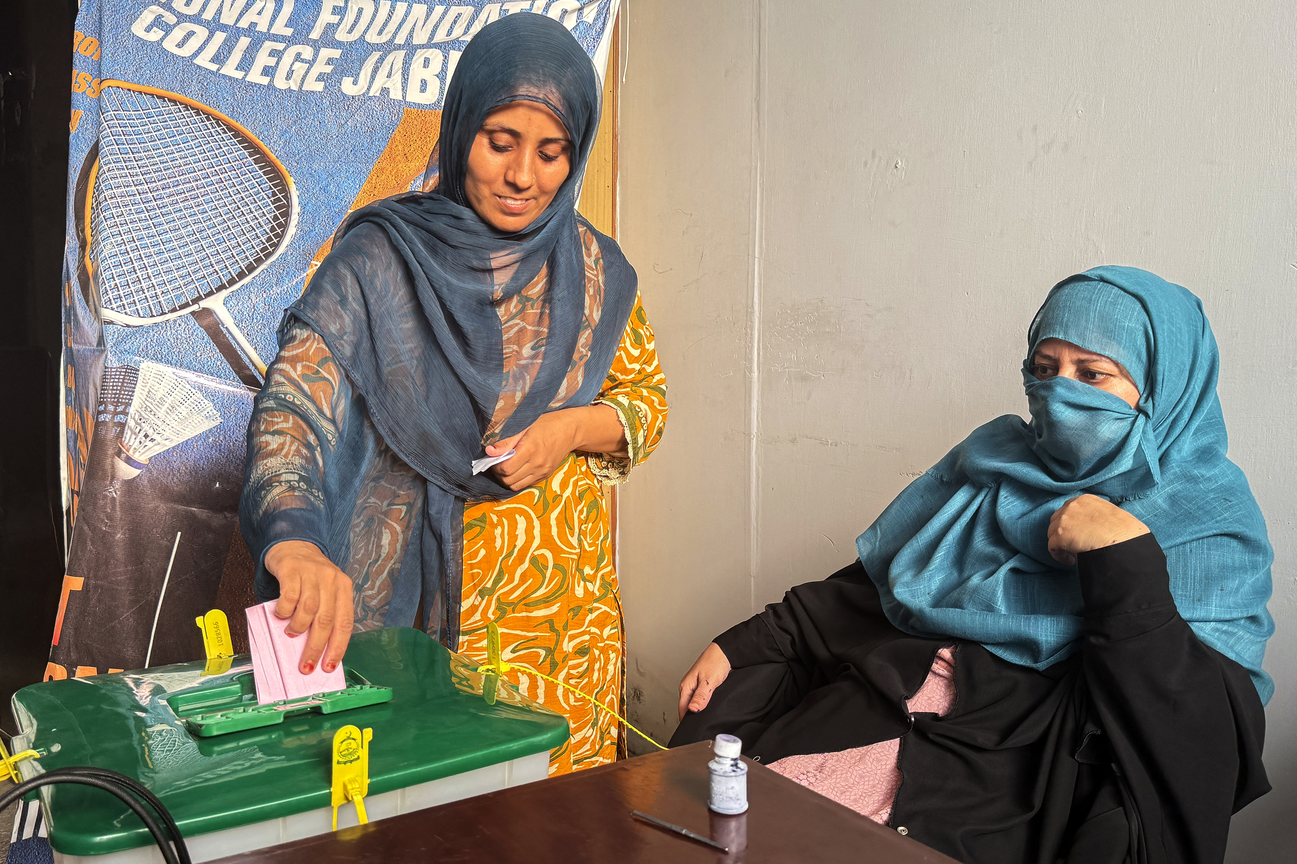 A voter casts her ballot at a polling station during the first phase of voting for the local legislature in Mirpur, in Pakistan-administered Kashmir, on July 27, 2026.