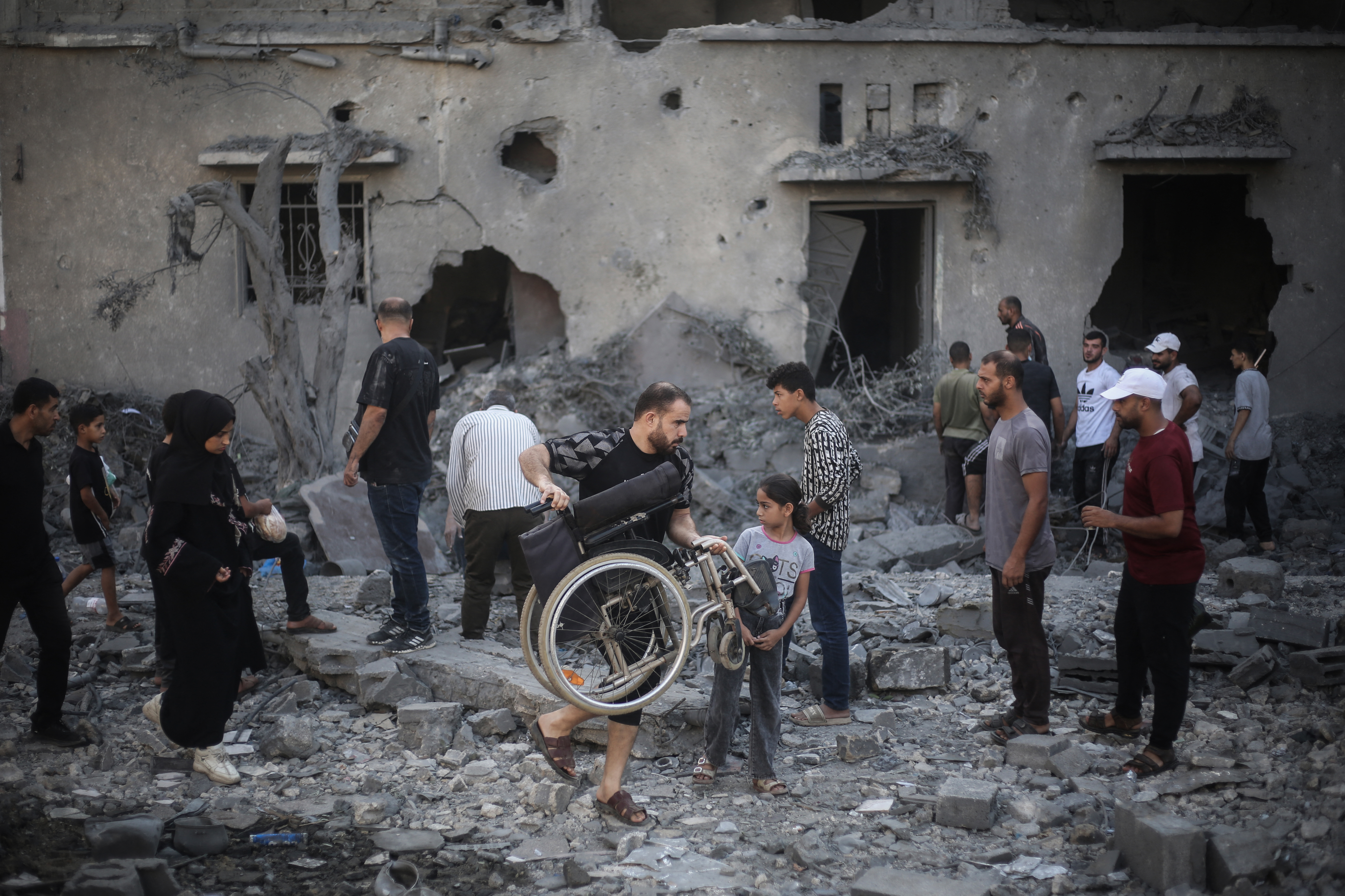 Palestinians inspect damaged and destroyed buildings after they were targeted by Israeli strikes the previous night in Deir al-Balah, central Gaza on July 29, 2026