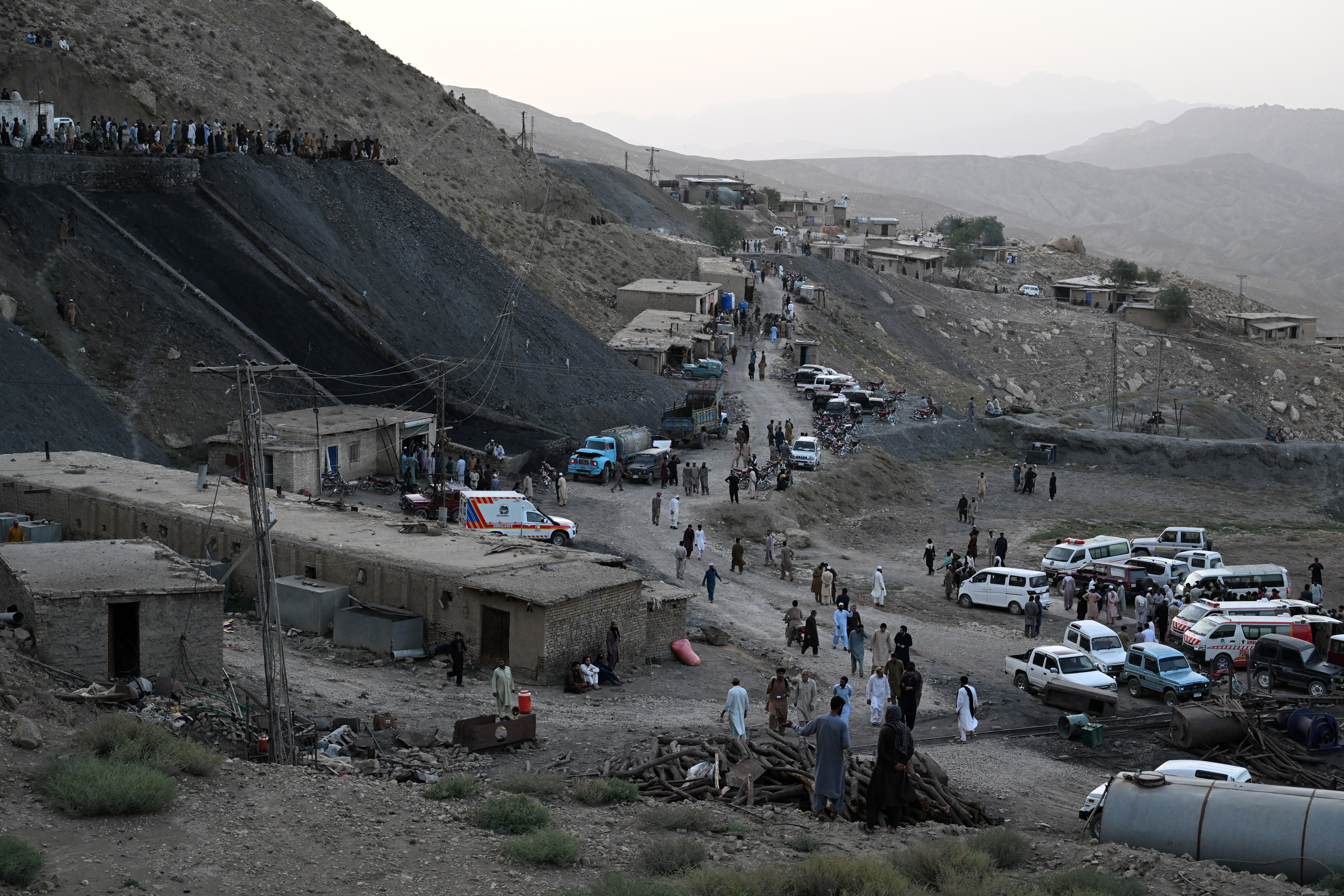 Coal miners and relatives gather after a coal mine collapsed in the Sorange area, some 50 kilometres (31 miles) east of Quetta, on July 30, 2026 [AFP]
