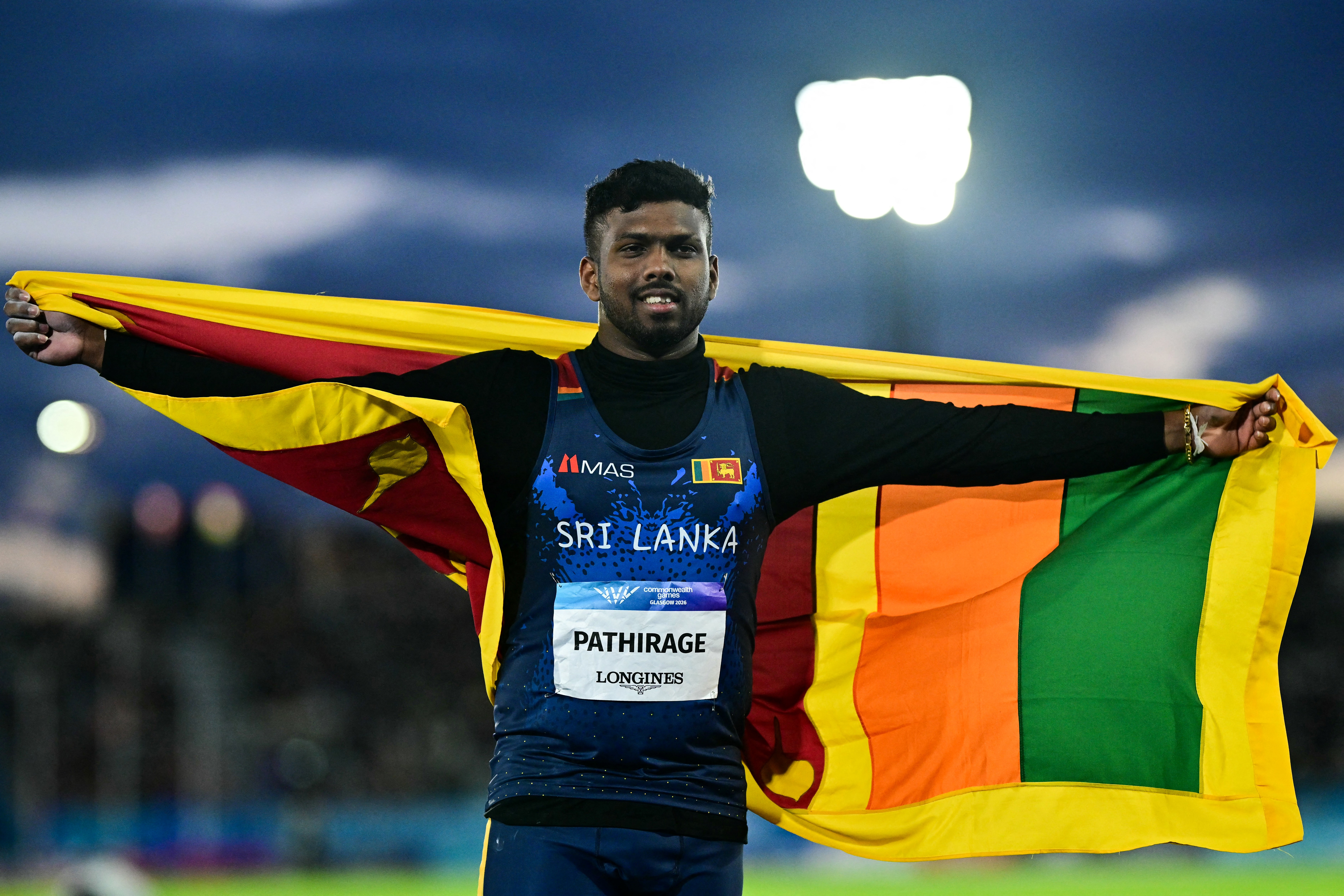 Winner Sri Lanka's Rumesh Tharanga Pathirage celebrates after competing in the men's javelin throw final during the athletics event at the Scotstoun Stadium in Glasgow, on day eight of the Commonwealth Games in Glasgow, Scotland, on July 31, 2026. (Photo by Ben STANSALL / AFP)