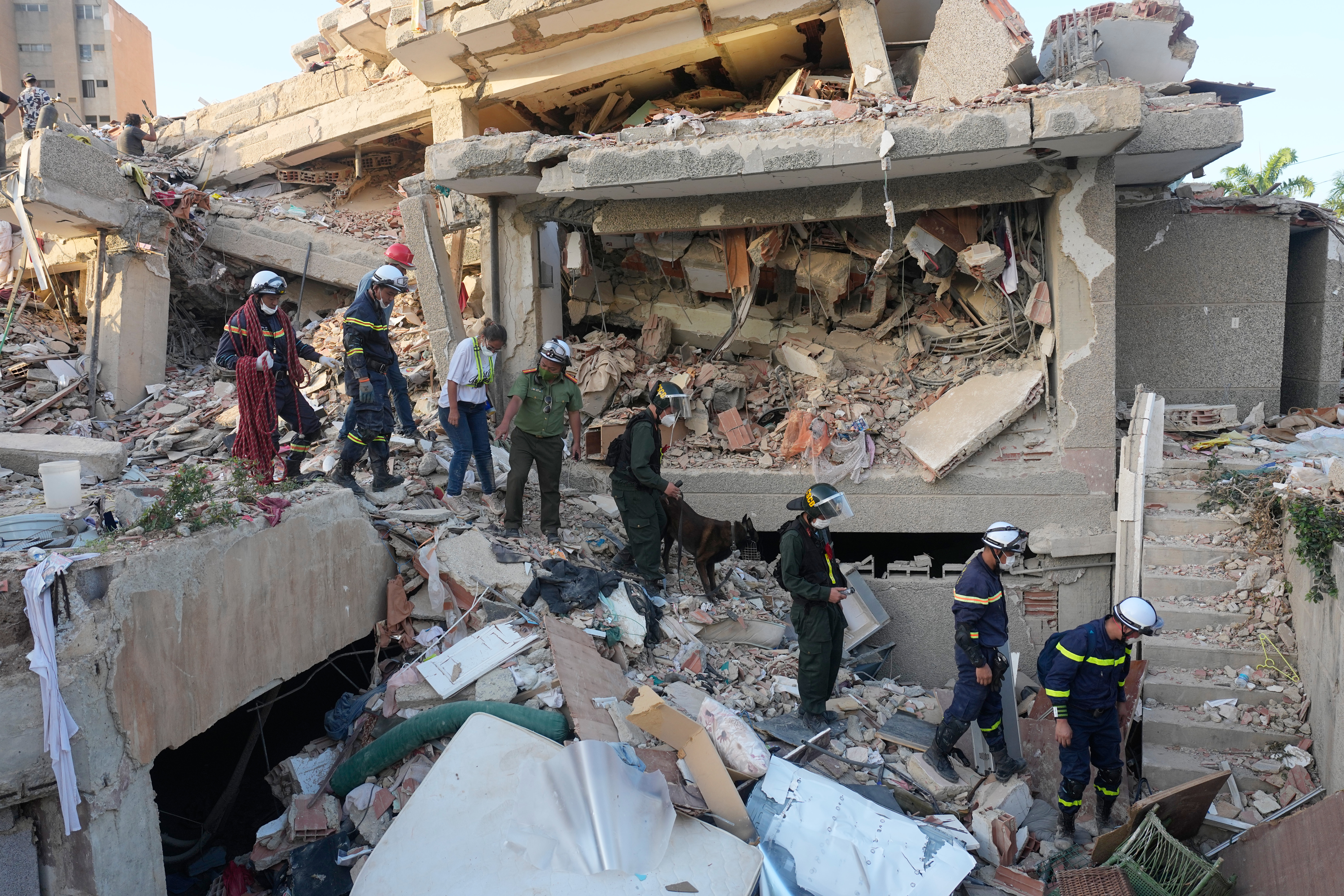 Vietnamese rescuers searches a building that collapsed during back-to-back earthquakes in Catia La Mar, Venezuela, Wednesday, July 1, 2026. (AP Photo/Fernando Vergara)