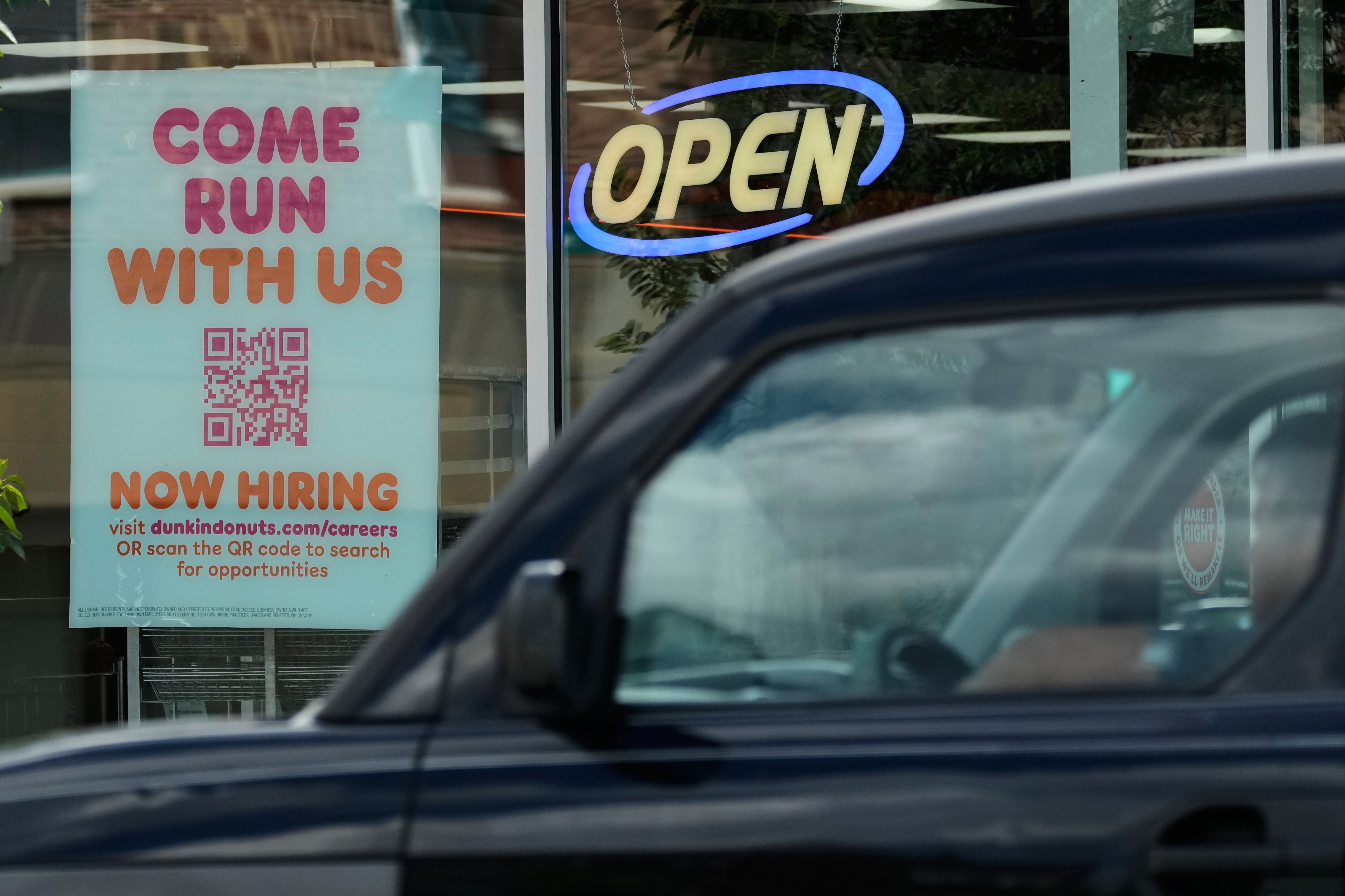 Now hiring sign is displayed at a Dunkin' in Niles, Ill., Thursday, June 25, 2026. (AP Photo/Nam Y. Huh)