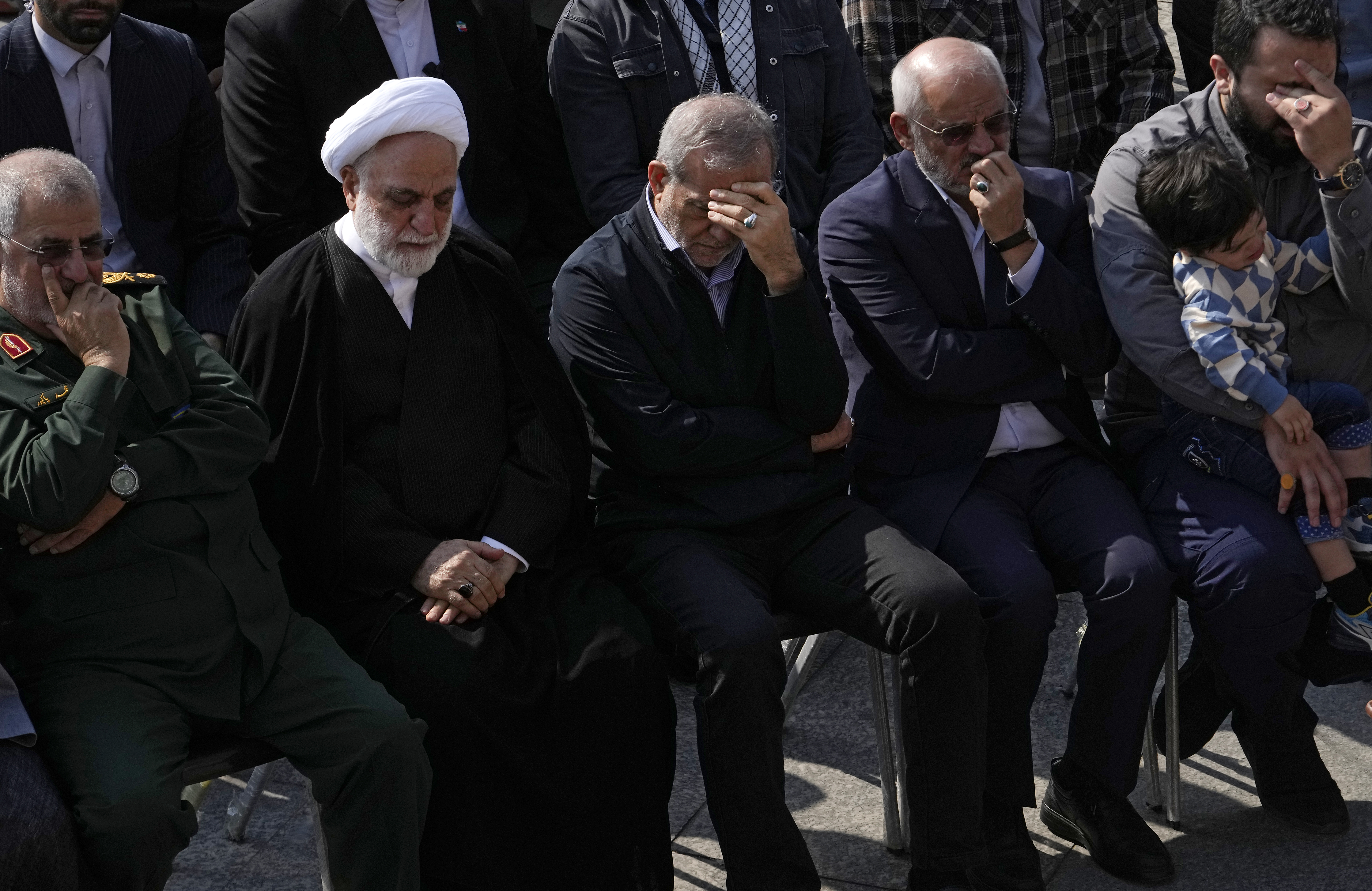 Iranian President Masoud Pezeshkian, center, Judiciary Chief Gholamhossein Mohseni Ejehi, second left, attend the funeral ceremony of the late Revolutionary Guard Gen. Abbas Nilforushan, in Tehran, Iran, Tuesday, Oct. 15, 2024. (AP Photo/Vahid Salemi)