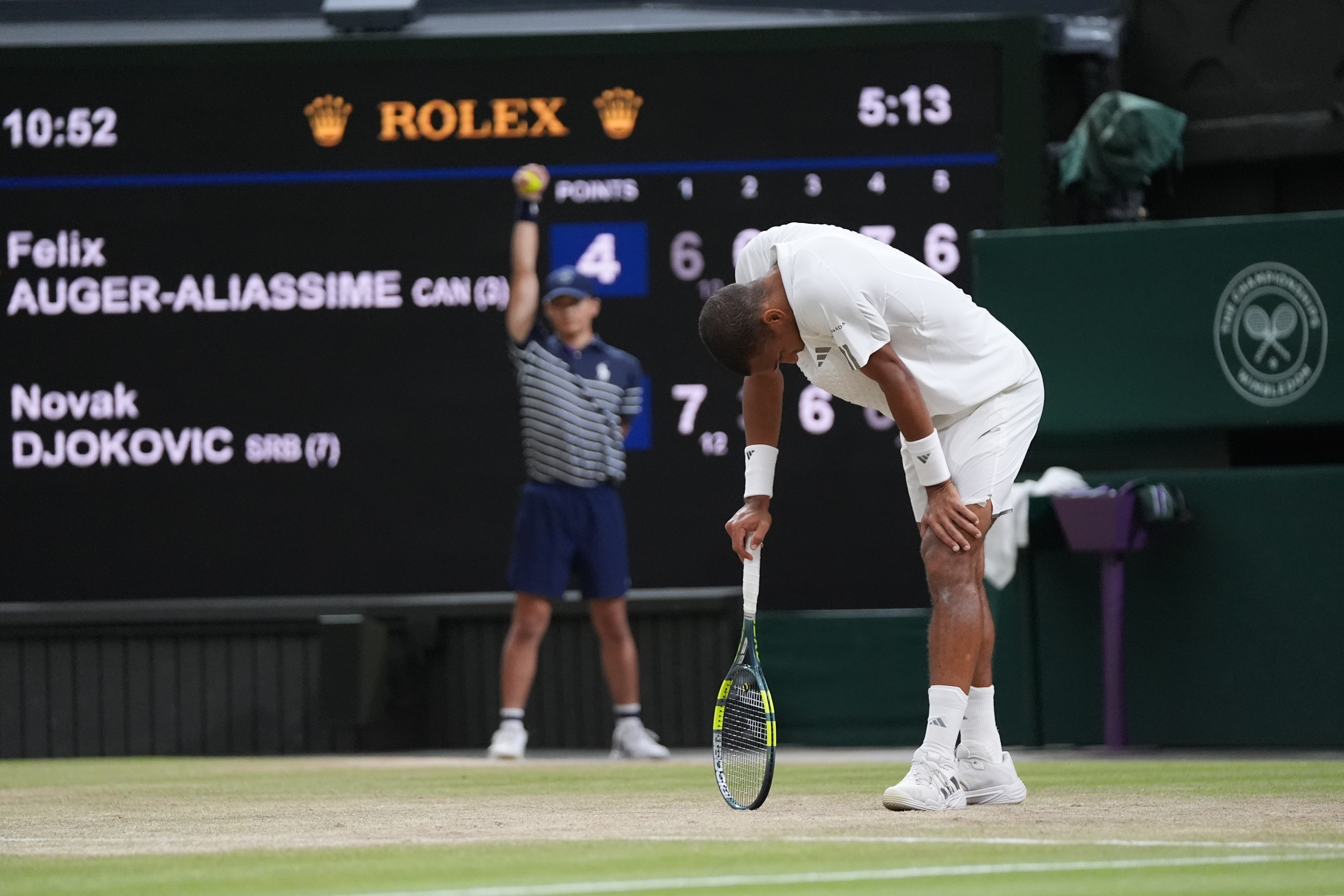 Felix Auger-Aliassime of Canada reacts after losing a point against Novak Djokovic of Serbia, as the match clock reaches five hours and 13 minutes, making it the longest Wimbledon men's singles quarterfinal in history, at the Wimbledon Tennis Championships in London, Tuesday, July 7, 2026. (AP Photo/Maja Smiejkowska)