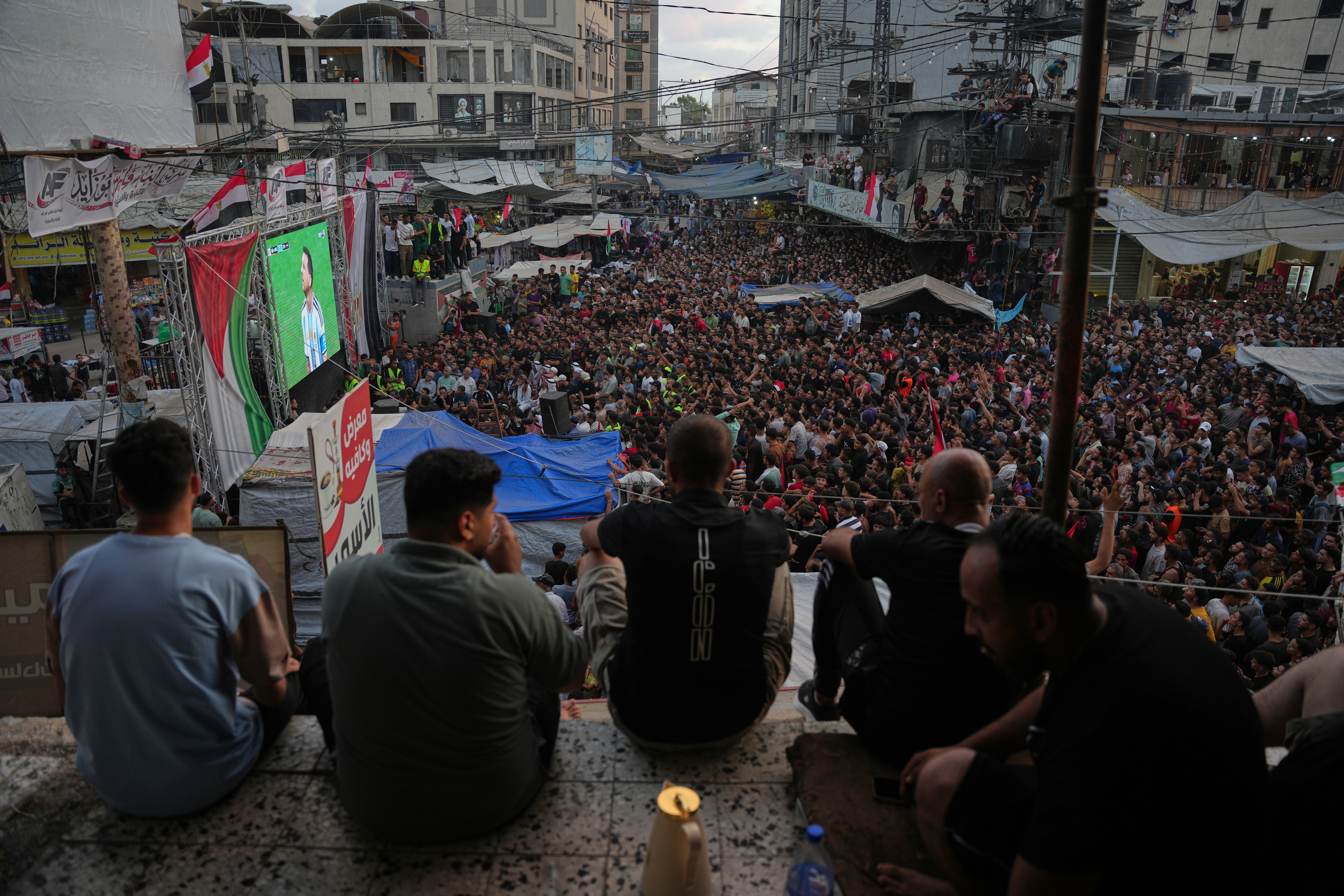 Palestinians watch a live broadcast of the World Cup round of 16 soccer match between Argentina and Egypt in Nuseirat, central Gaza Strip, Tuesday, July 7, 2026. (AP Photo/Abdel Kareem Hana)