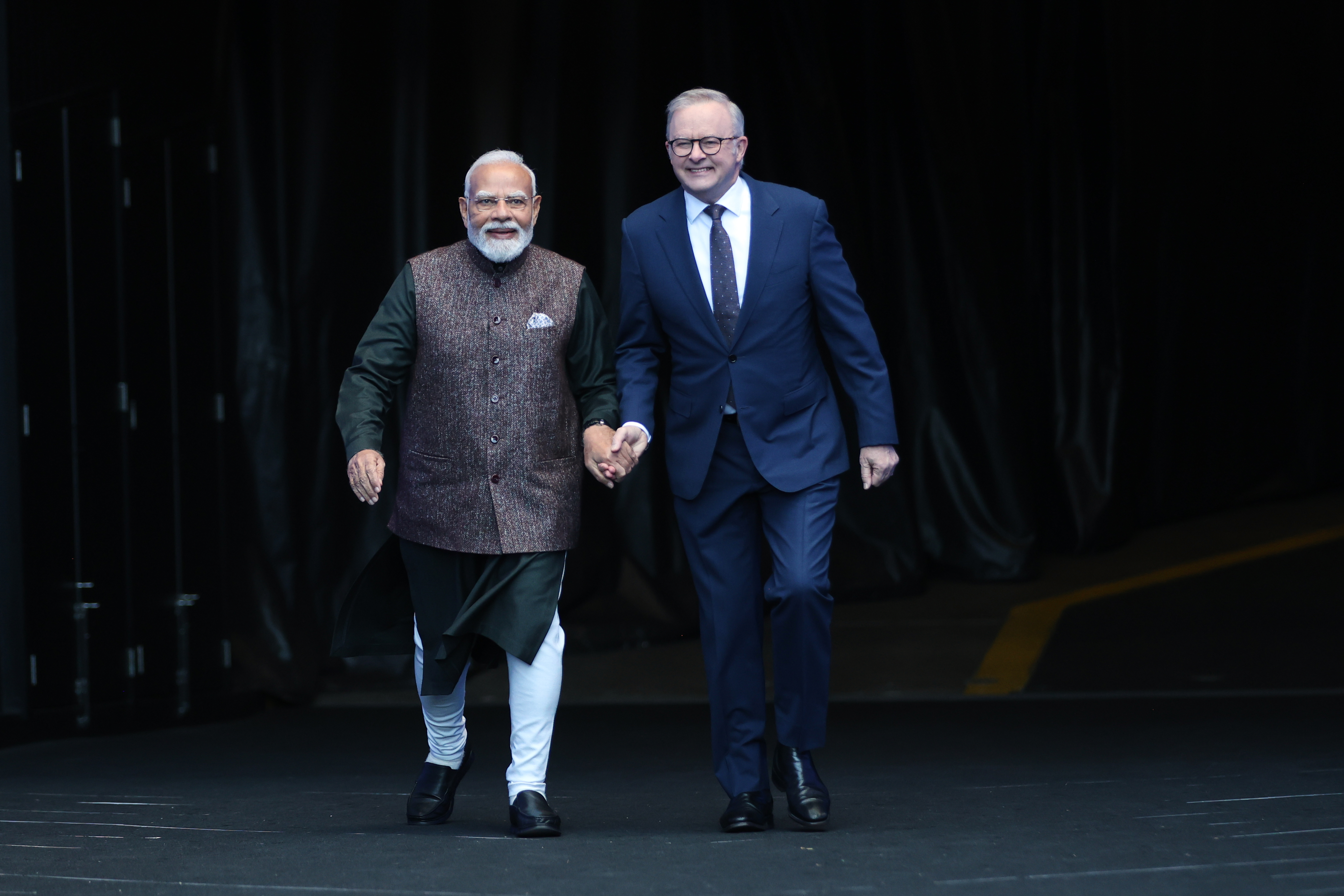 Indian Prime Minister Narendra Modi, left, and Australian Prime Minister Anthony Albanese walk together.
