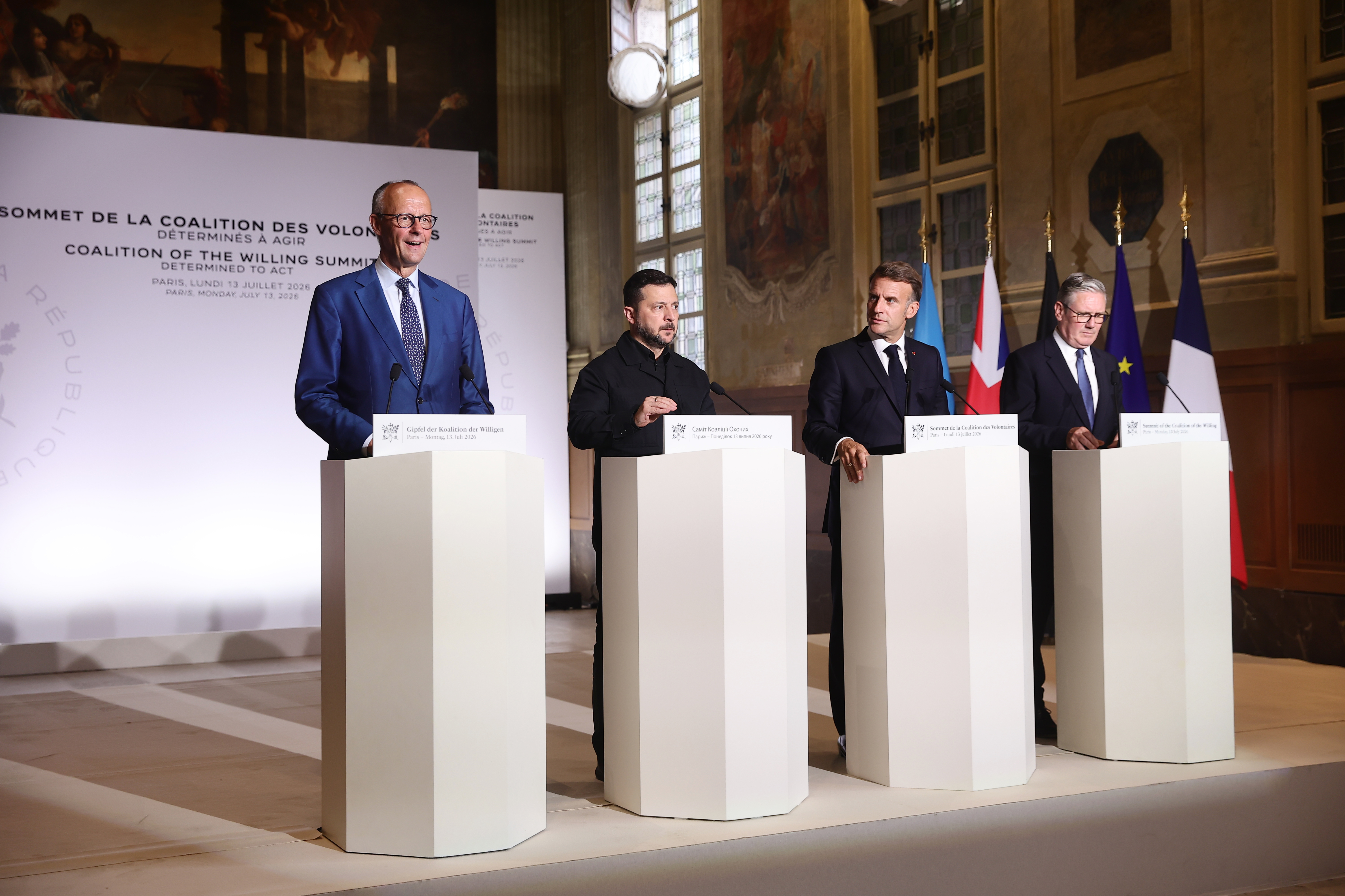 From left, German Chancellor Friedrich Merz, Ukrainian President Volodymyr Zelensky, French President Emmanuel Macron, and British Prime Minister Keir Starmer address a press conference after the Coalition of the Willing summit on security guarantees for Ukraine in Paris, Monday, July 13, 2026. (Teresa Suarez/Pool Photo via AP)