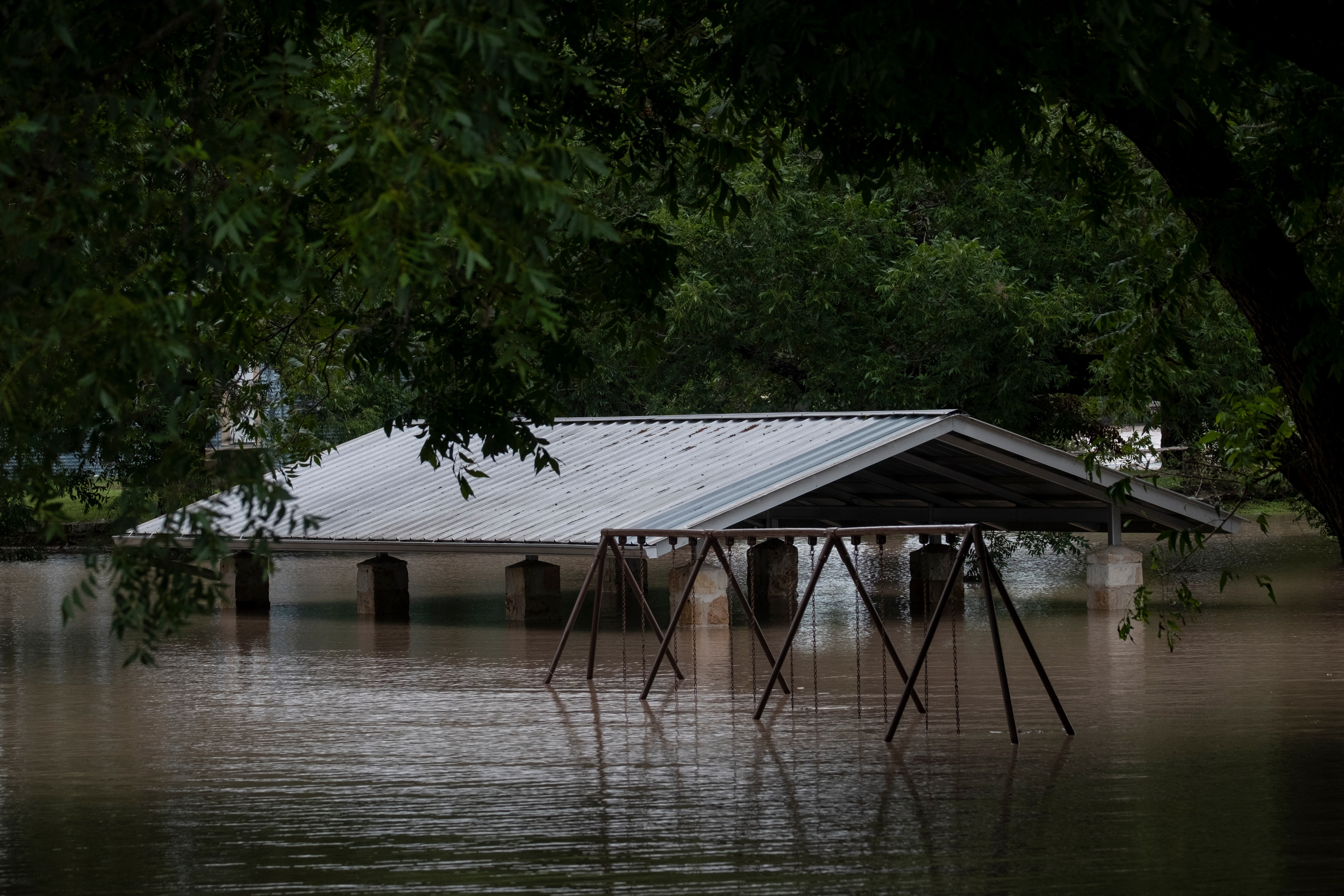 Water along the Pedernales River floods the Gillespie County Safety Rest Area on Thursday, July 16, 2026, in Stonewall, Texas. (AP Photo/Joel Angel Juarez)