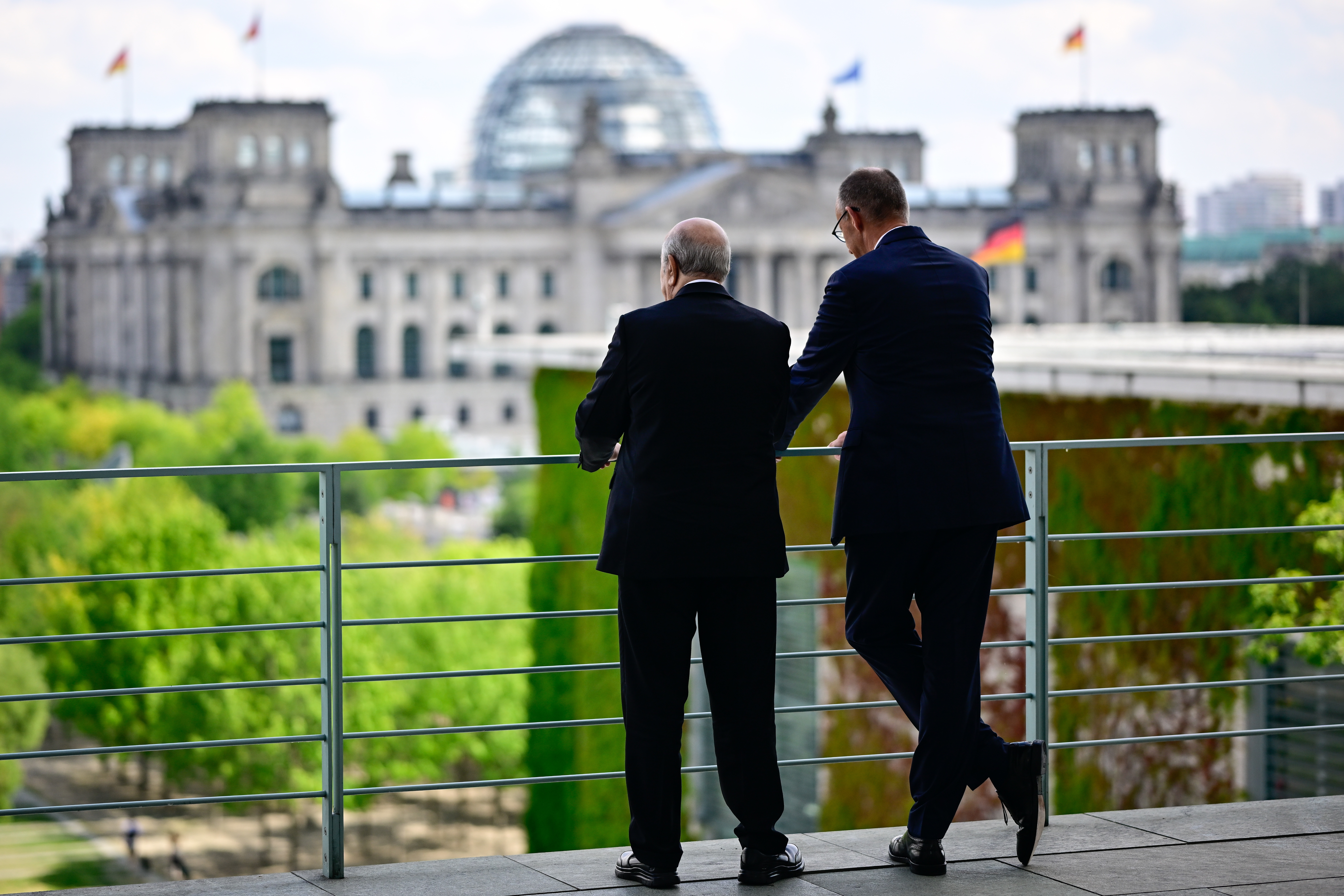 German Chancellor Friedrich Merz, right, and Algeria's President Abdelmadjid Tebboune talk on the terrace of the Chancellery, in Berlin, Thursday July 16, 2026. (Tobias Schwarz/Pool Photo via AP)