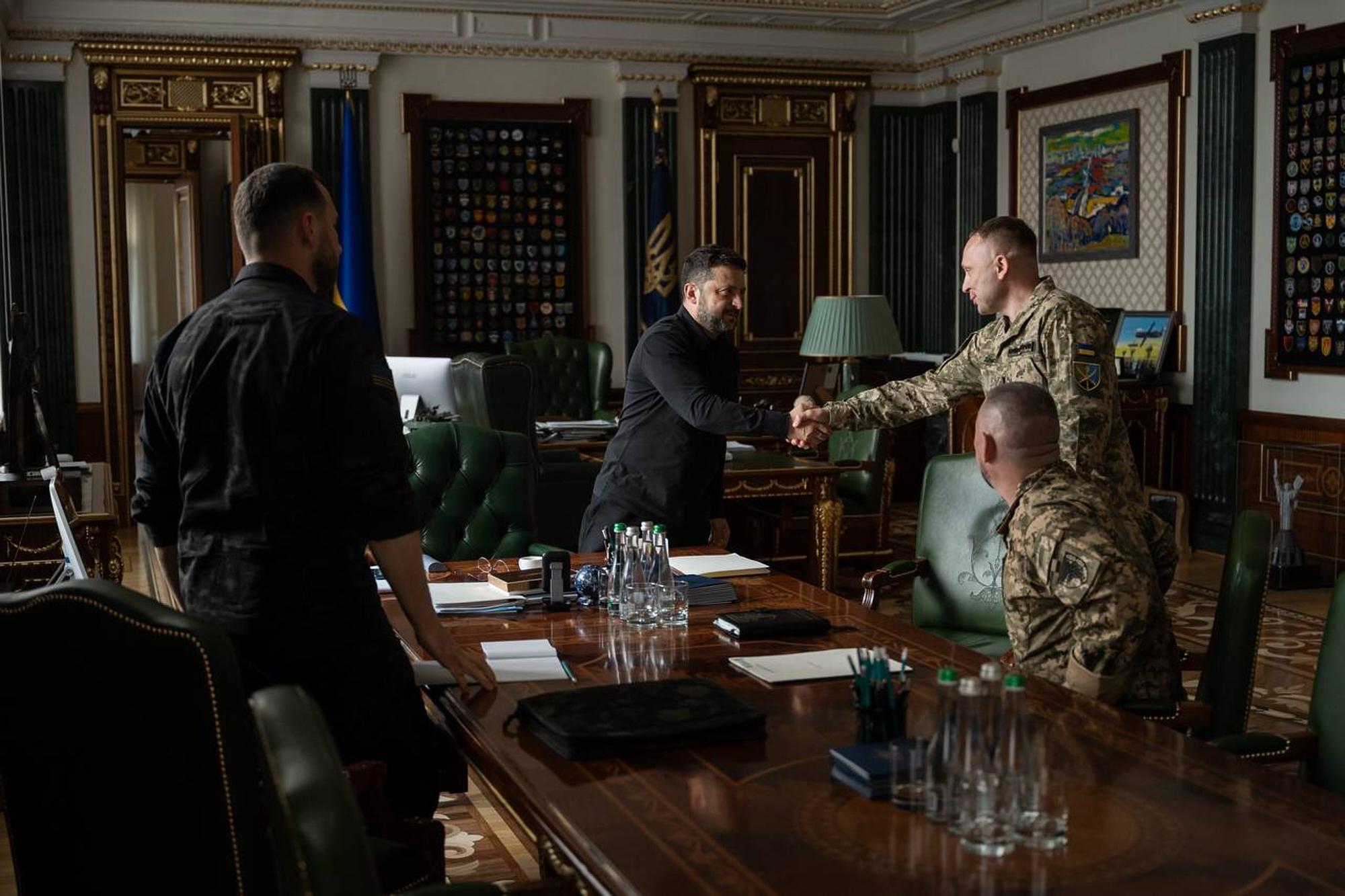 In this photo provided by the Ukrainian Presidential Press Office, Ukrainian President Volodymyr Zelenskyy, center, shakes hands with new commander-in-chief of Ukraine's Armed Forces Mykhailo Drapatyi during their meeting in Kyiv, Ukraine, Monday, July 20, 2026. (Ukrainian Presidential Press Office via AP)