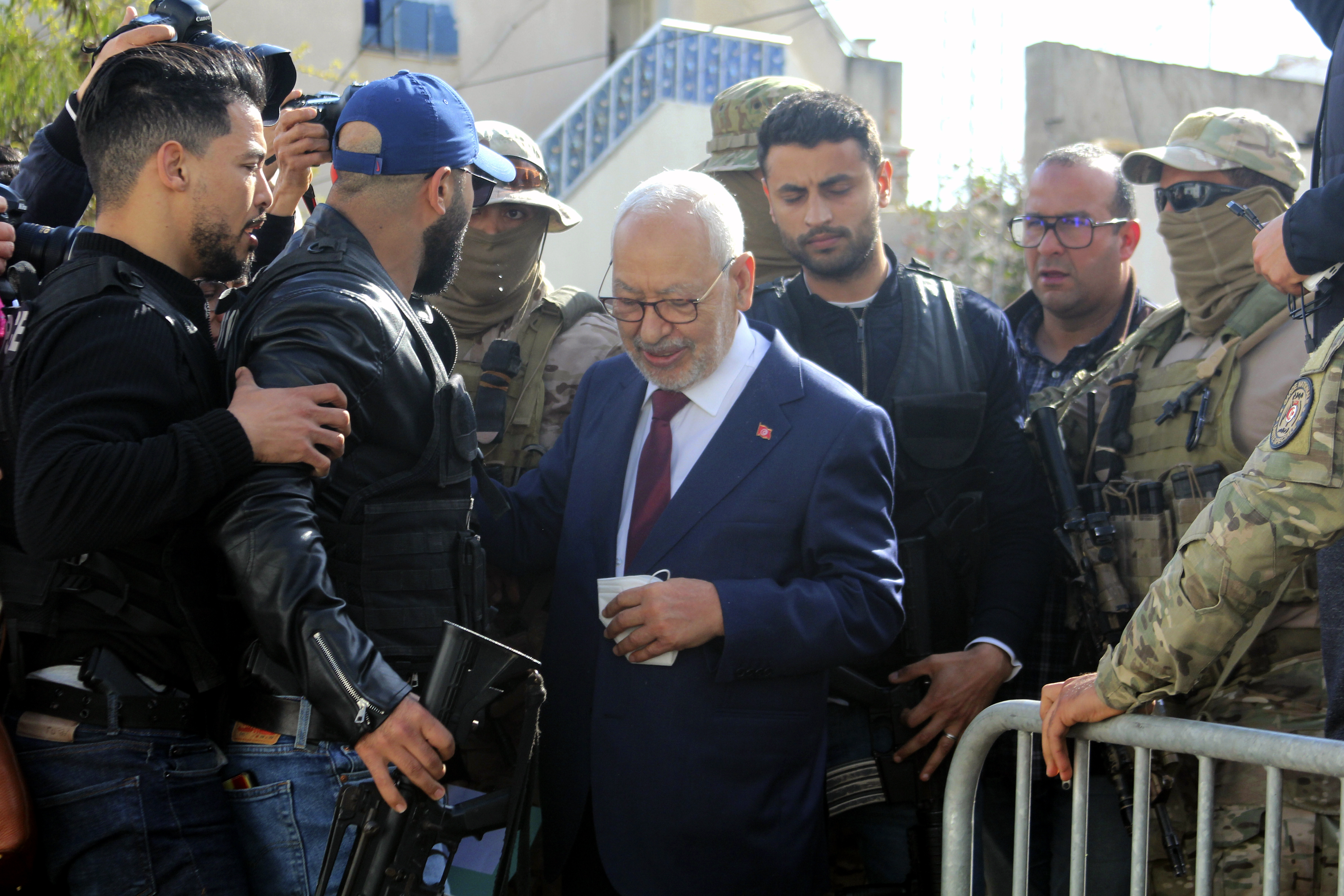 Leader of Tunisia's Islamist Ennahda party House Speaker Rached Ghannouchi, center, arrives for questioning at the judicial police headquarters in Tunis, Tunisia, Friday, April 1, 2022. (AP Photo/Hassene Dridi)