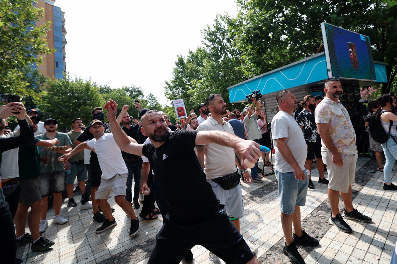 A protestor throws eggs as violent clashes erupt