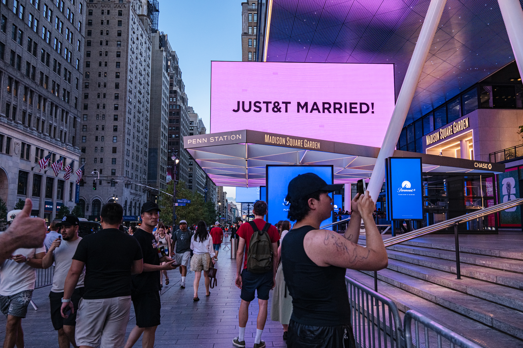 epa13084946 'Swifties', Taylor Swift fans, take photos outside Madison Square Garden during Taylor Swift and Travis Kelce's wedding celebration in New York, New York, USA, 03 July 2026. EPA/LAURA BRETT