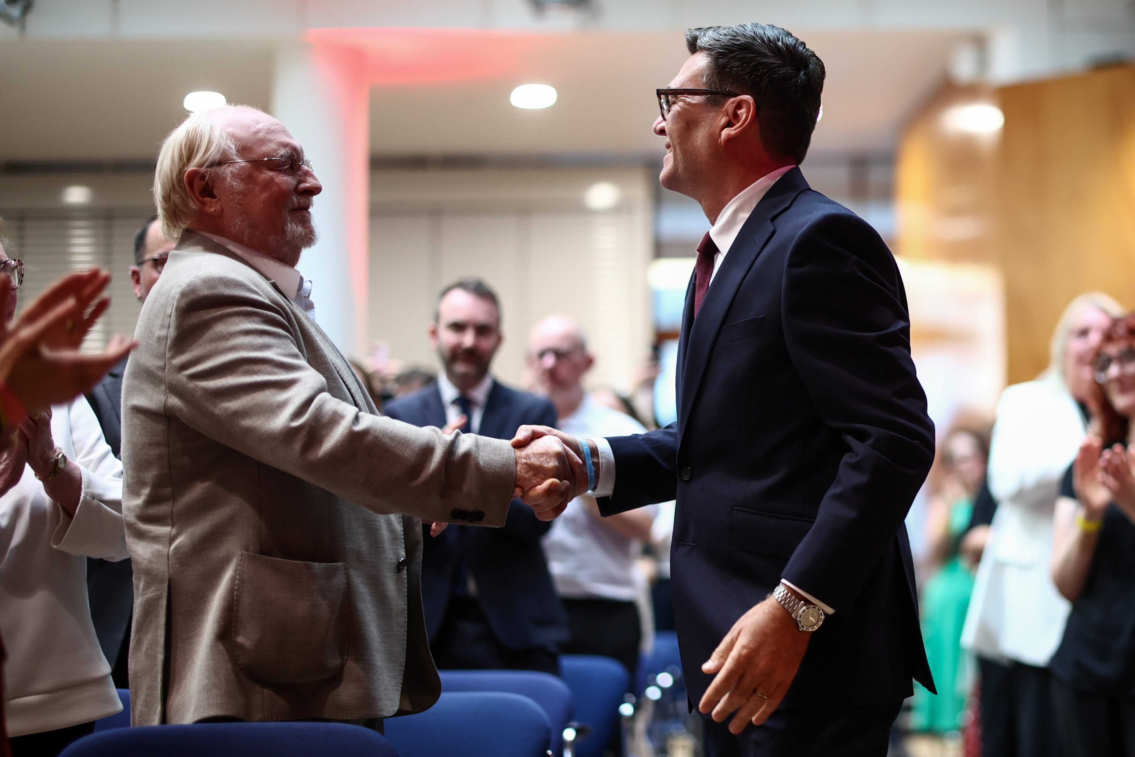 epa13117115 Andy Burnham (R) shakes hands with Neil Kinnock (L), former Labour Party leader in the 1980's and 1990's, as he arrives before being confirmed as the Labour Party's new leader and the country's next prime minister during 'Labour’s Special Conference' in central London, Britain, 17 July 2026. Burnham is expected to offcially become Britain's prime minister on 20 July 2026. EPA/HENRY NICHOLLS / POOL