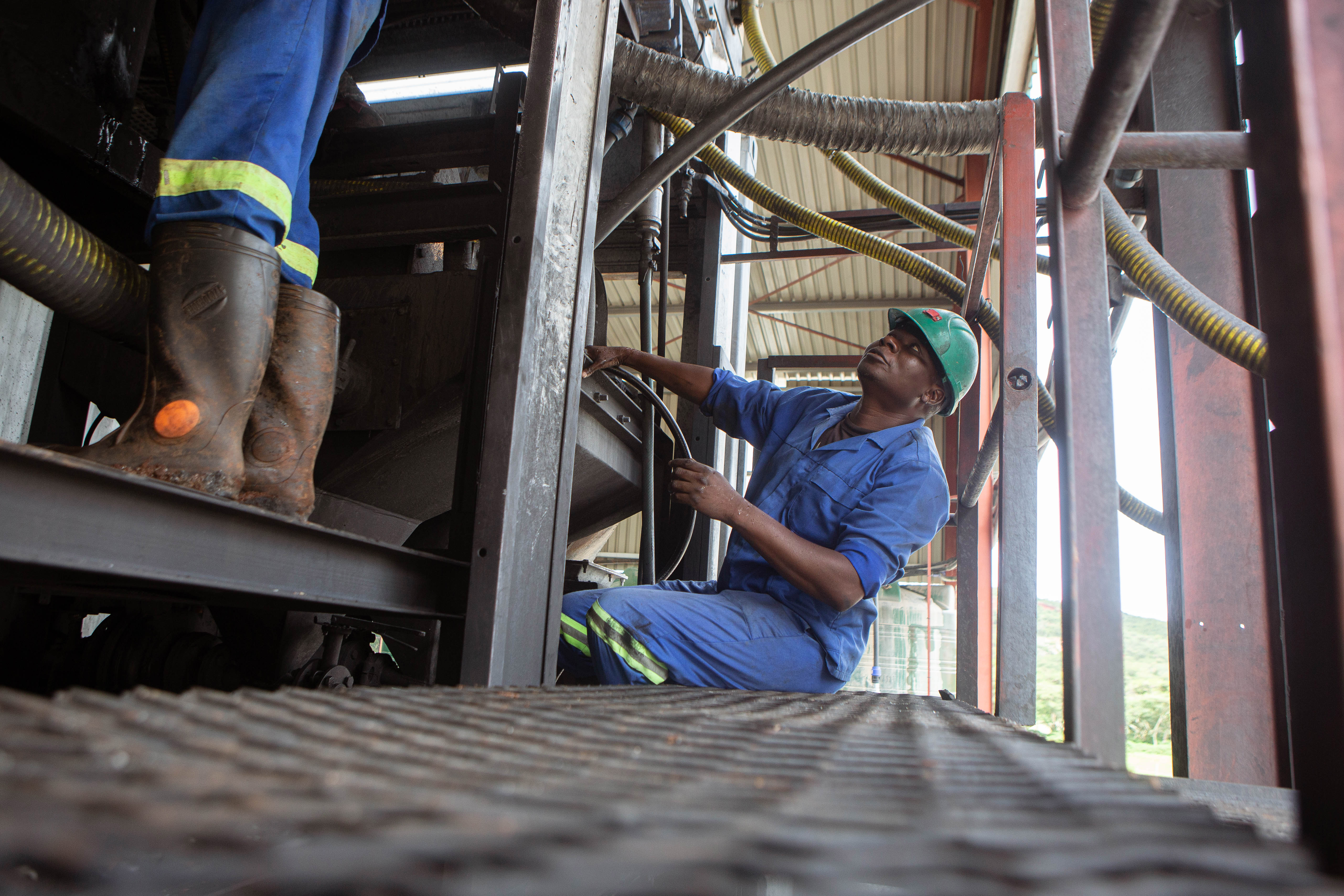 Mechanics work on a machine installed at Arcadia Lithium in Goromonzi, Zimbabwe [Tafadzwa Ufumeli/Getty Images]