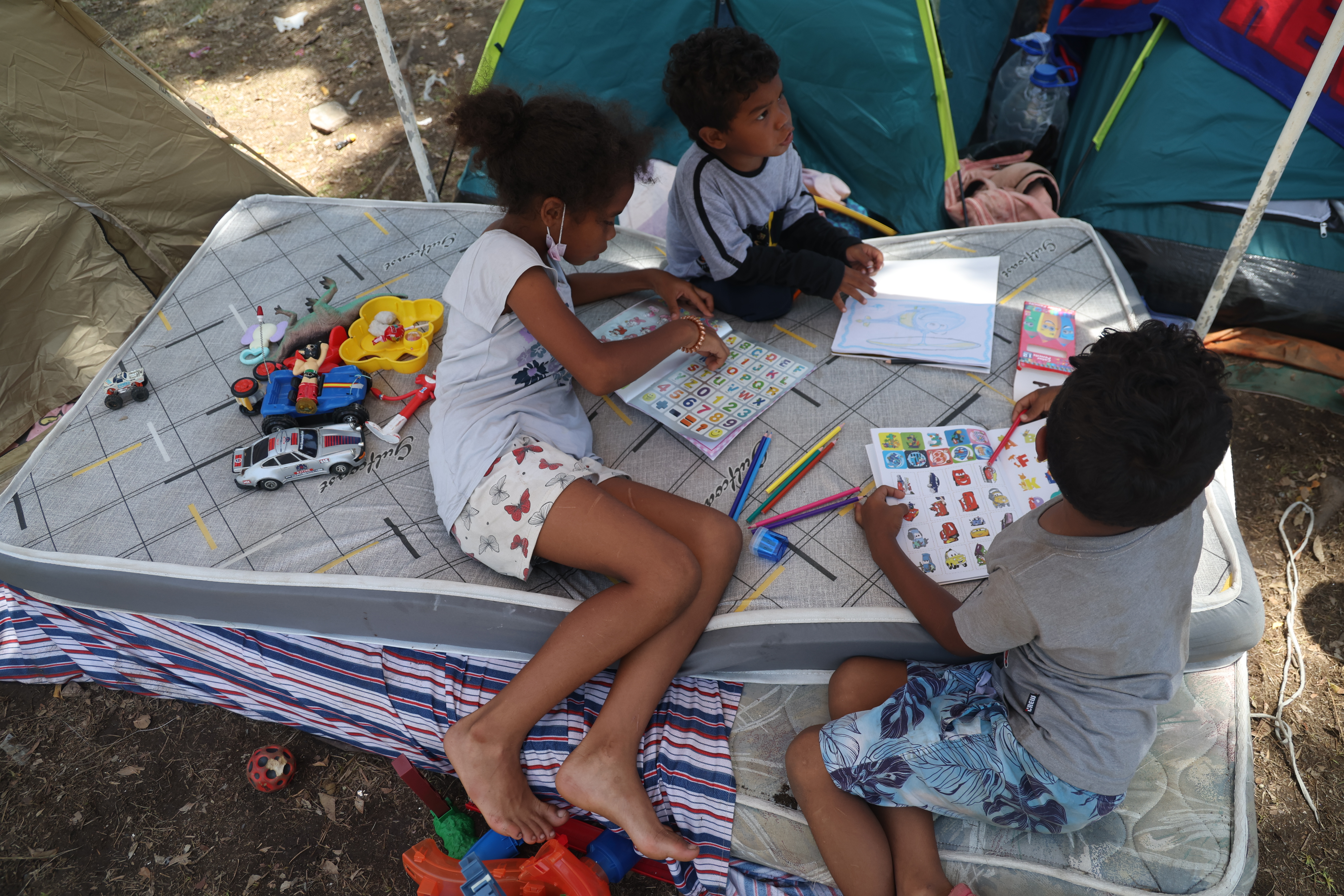 LA GUAIRA, VENEZUELA - JULY 01: Children play under a tent after the earthquakes that struck Venezuela and other regions in the Caribbean, on July 1, 2026 in La Guaira, Venezuela. According to the U.S. Geological Survey (USGS), the main earthquake on June 24, 2026 was followed by a 7.5-magnitude aftershock less than a minute later. The number of fatal victims increased to 2295, while the number of injured people exceeded 10,000. More than 70,000 people are reported missing. (Photo by Edilzon Gamez/Getty Images)