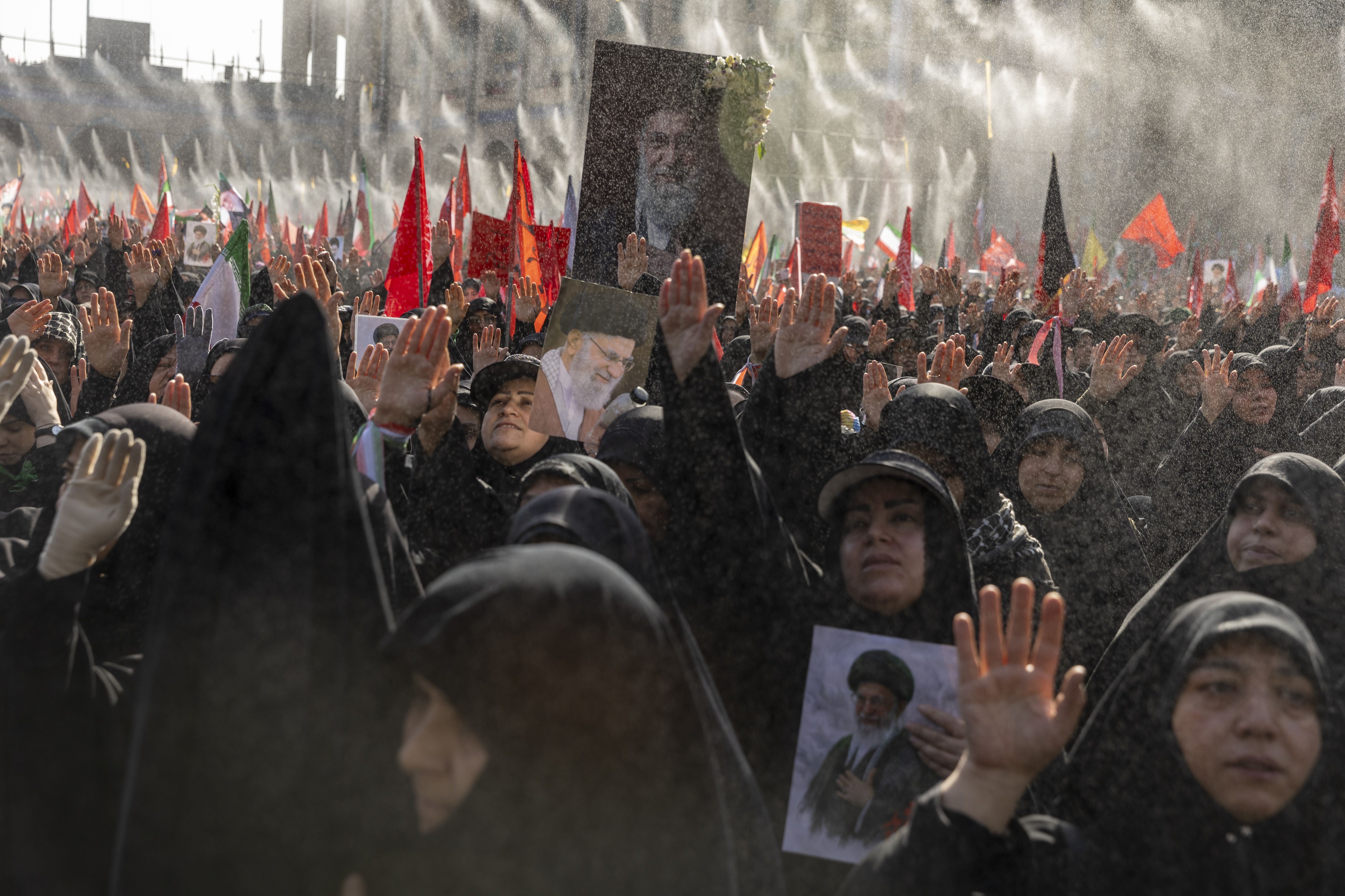 TEHRAN, IRAN - JULY 5: People gesture as they hold portraits of Iran's late Supreme Leader, Ayatollah Ali Khamenei, during the second day of his funeral ceremonies at the Grand Mosalla on July 5, 2026 in Tehran, Iran. Khamenei and members of his family were killed on February 28 during U.S.-Israeli strikes at the beginning of the war, bringing an end to his 36-year rule over Iran. A multi-city state funeral will be held over six days before his body is laid to rest on July 9, in his hometown of Mashhad, Iran. (Photo by Majid Saeedi/Getty Images)