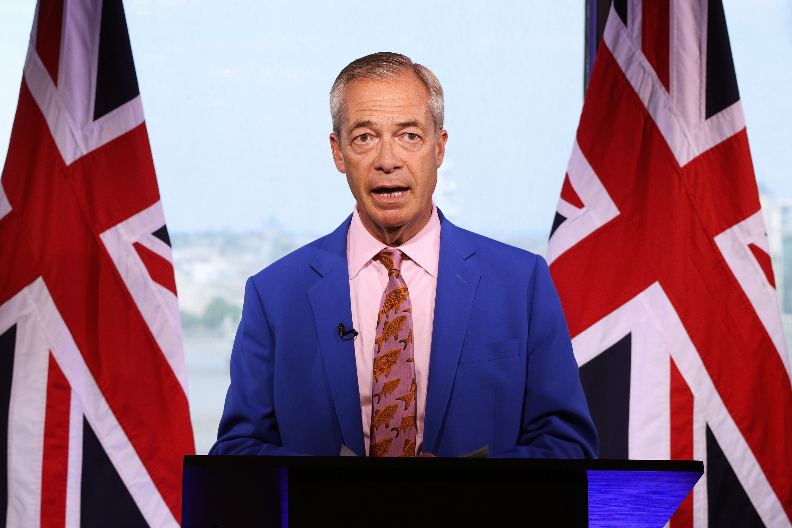 LONDON, ENGLAND - JULY 7: Reform UK Leader Nigel Farage announces his resignation as a member of parliament while giving a statement on his "future in public life" at Millbank Tower on July 7, 2026 in London, England. Farage added that he would stand in the by-election triggered by his resignation. The remarks came amid renewed scrutiny over financial support he received ahead of his election as Clacton MP. (Photo by Dan Kitwood/Getty Images)