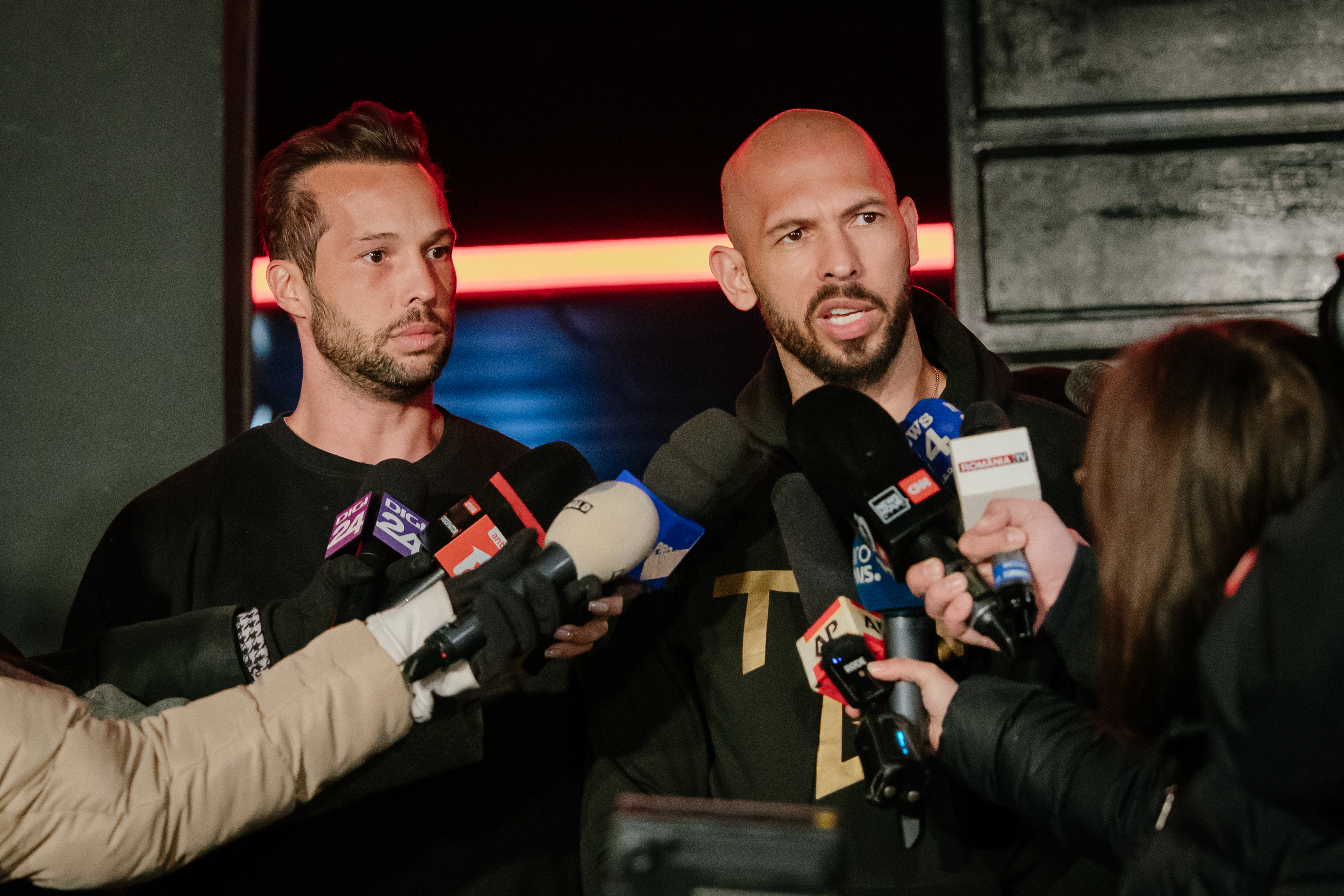 Two men speaking into microphones