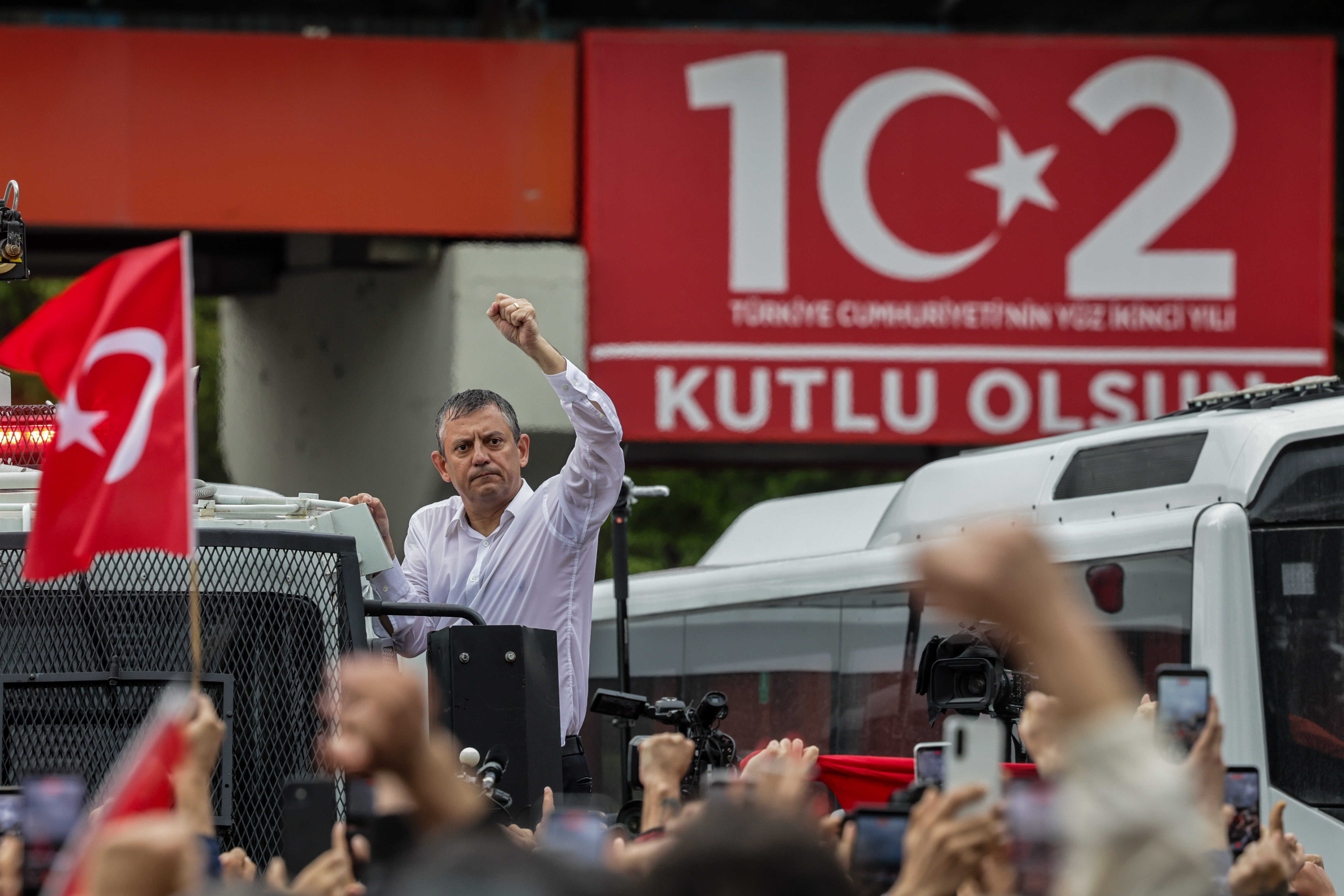 ANKARA, TURKEY - MAY 24: Turkey’s main opposition Republican People's Party's (CHP) Ousted party leader Ozgur Ozel waves to supporters from atop a police water cannon vehicle after being forcibly evicted by police from his party’s headquarters on May 24, 2026 in Ankara, Turkey. Police forcibly took control of the headquarters of Turkey’s main opposition Republican People's Party (CHP) in Ankara, using tear gas and rubber bullets to remove party leader Ozgur Ozel and his supporters after he refused to leave the building. The intervention followed a Turkish court ruling that annulled the CHP’s 2023 congress over alleged voting irregularities, removing Ozel from office and reinstating former opposition leader Kemal Kilicdaroglu. The decision triggered clashes and protests among rival groups of party supporters. (Photo by Serdar Ozsoy/Getty Images)