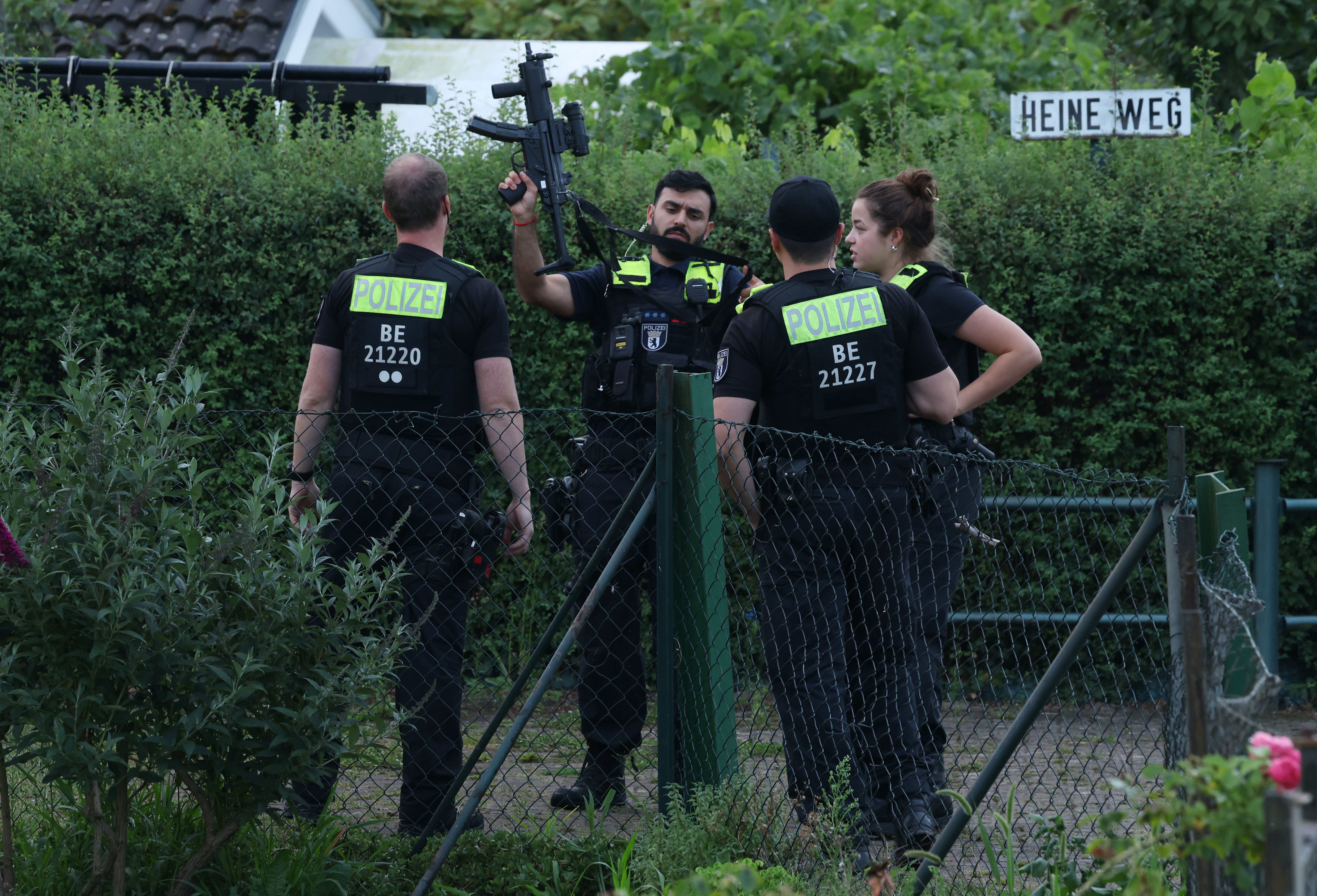 BERLIN, GERMANY - JULY 26: Heavily-armed police stand in a garden house colony in Spandau district where they reportedly confronted and shot dead Abdul B., the main suspect in last night's attack against revelers of the Christopher Street Day Berlin pride parade on July 26, 2026 in Berlin, Germany. At approximately 10:00pm last night Abdul B. is suspected of having driven the van into a crowd in Tiergarten park, killing one woman and injuring over 16. (Photo by Sean Gallup/Getty Images)