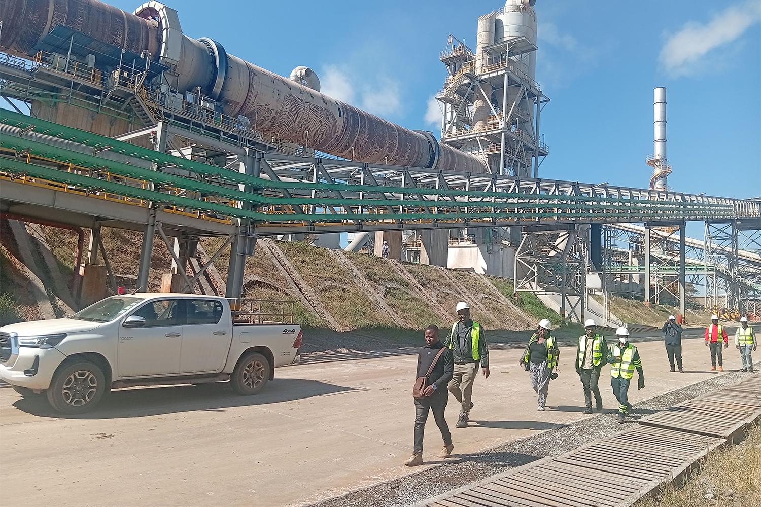 Journalists walk past Prospect Lithium Zimbabwe's (PLZ) newly constructed lithium sulphate plant during a technical media tour in Goromonzi, Mashonaland East. The facility, one of Africa's largest three-line single-phase lithium sulphate plants, forms part of Zimbabwe's drive to promote local mineral beneficiation and value addition [Enos Denhere/Al Jazeera]