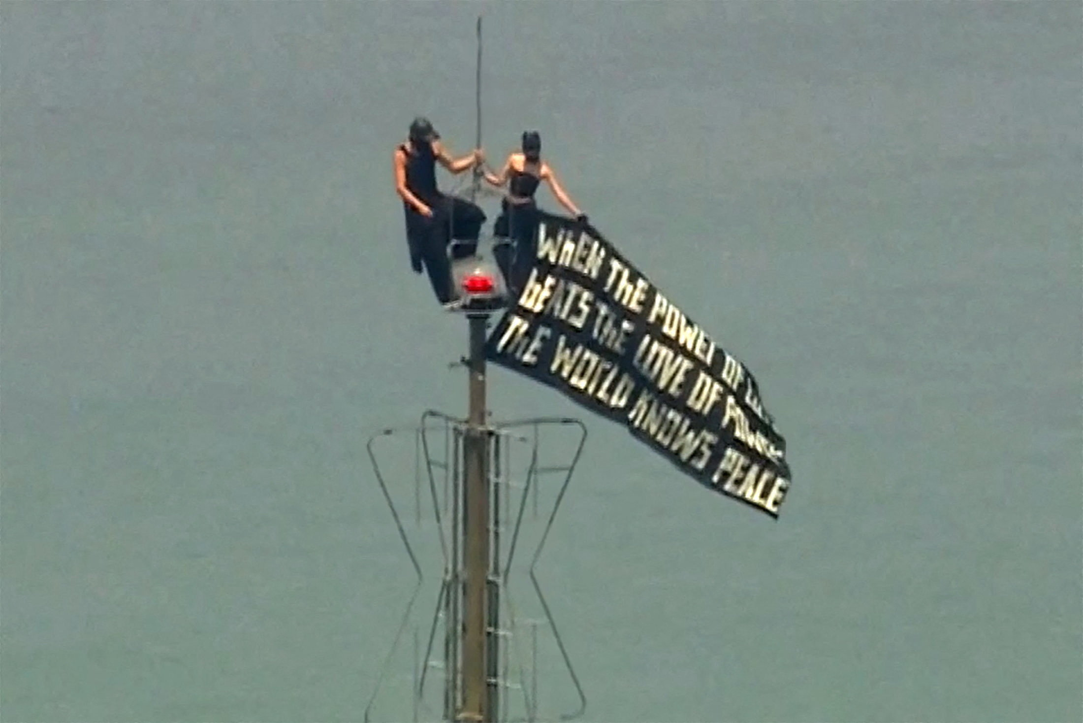 Two people display a banner atop the Empire State Building in the Manhattan borough of New York, U.S., July 1, 2026, in a still image from video. ABC Affiliate WABC/Handout via REUTERS. NO RESALES. NO ARCHIVES. THIS IMAGE HAS BEEN SUPPLIED BY A THIRD PARTY