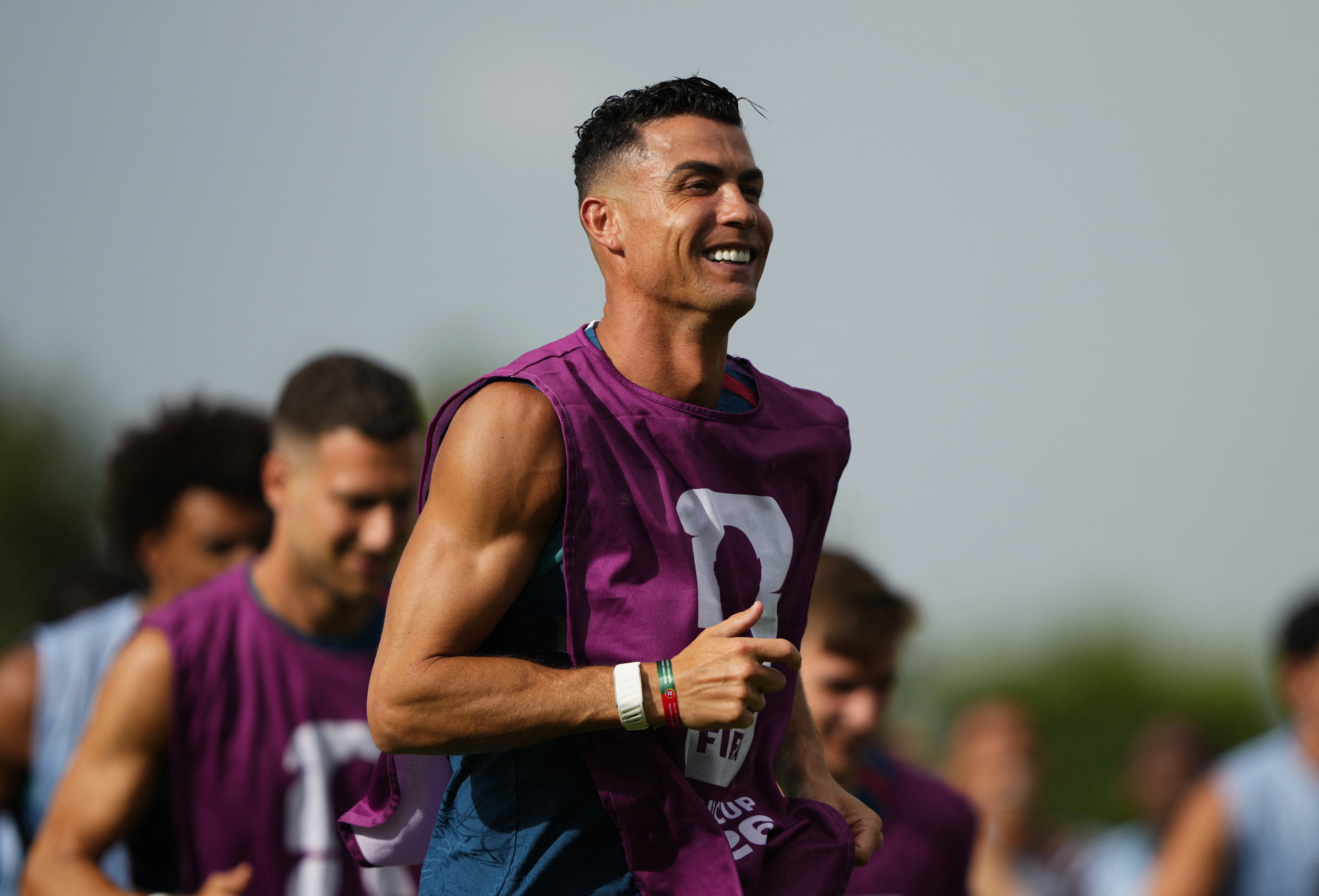 A football player running on the pitch in training