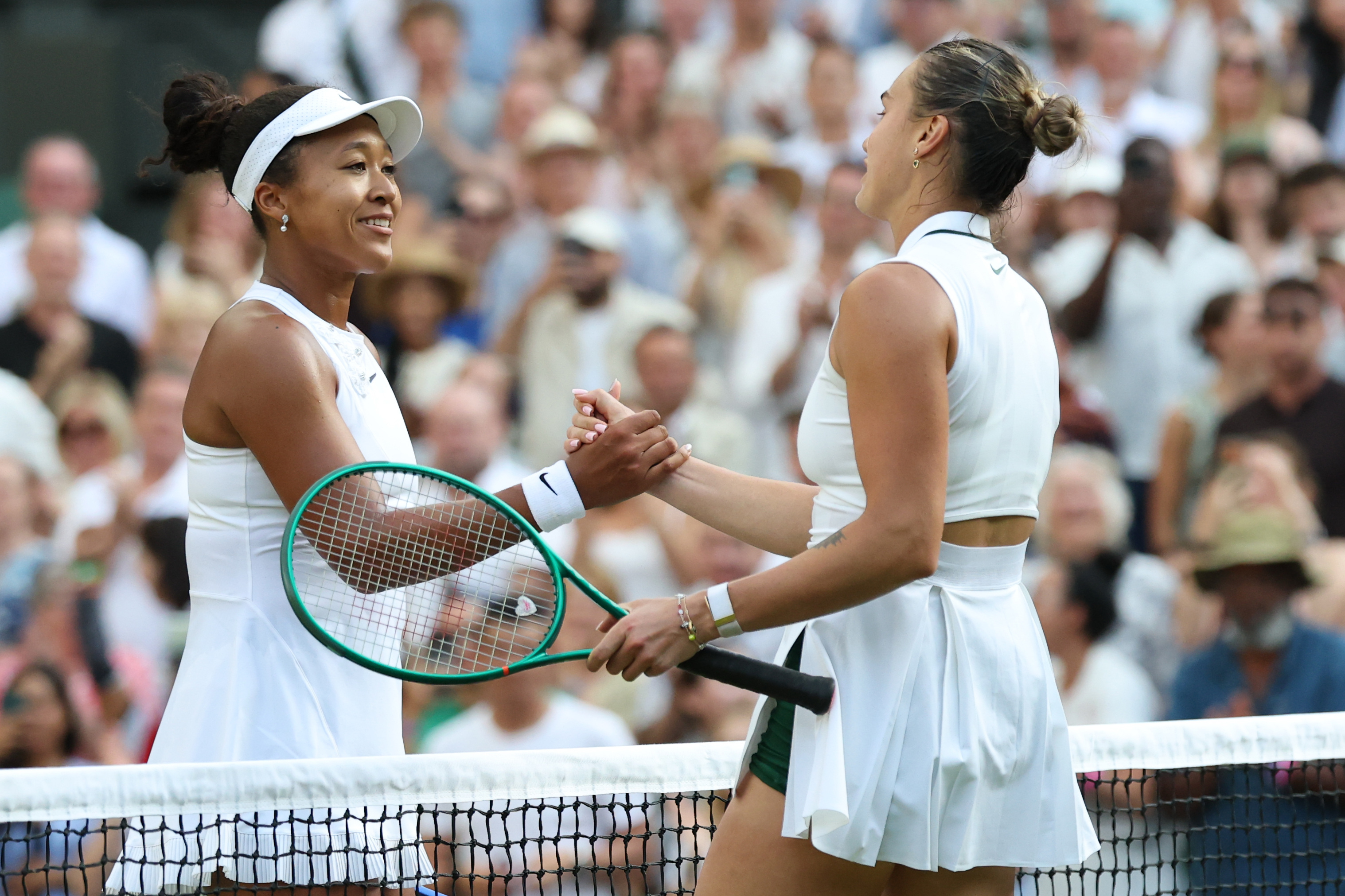 Jul 5, 2026; London, United Kingdom; Naomi Osaka (JPN) (L) shakes hands with Aryna Sabalenka (R) at the net after their match on day seven of The Championships Wimbledon 2026 at All England Lawn Tennis and Croquet Club. Mandatory Credit: Geoff Burke-Imagn Images