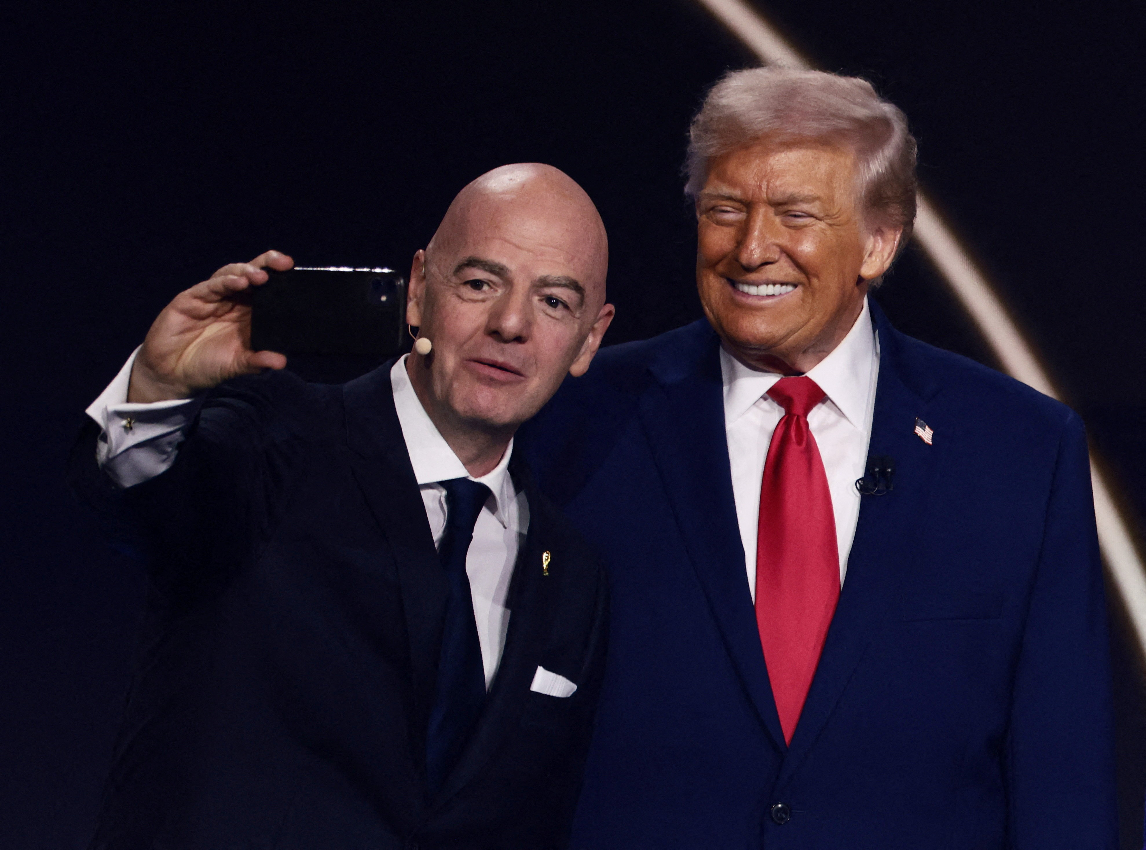 Two men pose for a selfie together