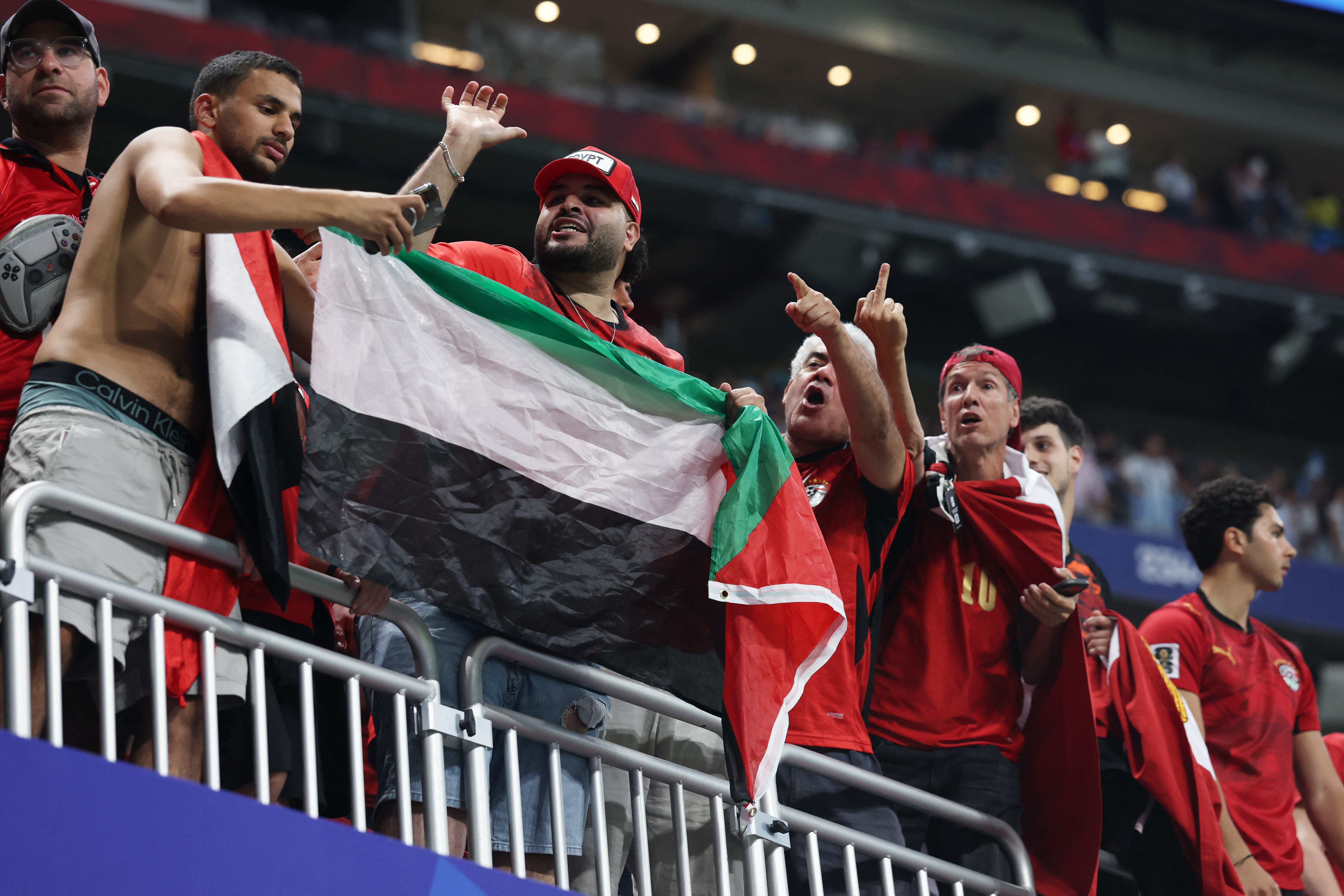Soccer Football - FIFA World Cup 2026 - Round of 16 - Argentina v Egypt - Atlanta Stadium, Atlanta, Georgia, U.S. - July 7, 2026 Egypt fans with a Palestine flag in the stands after the match REUTERS/Paul Childs