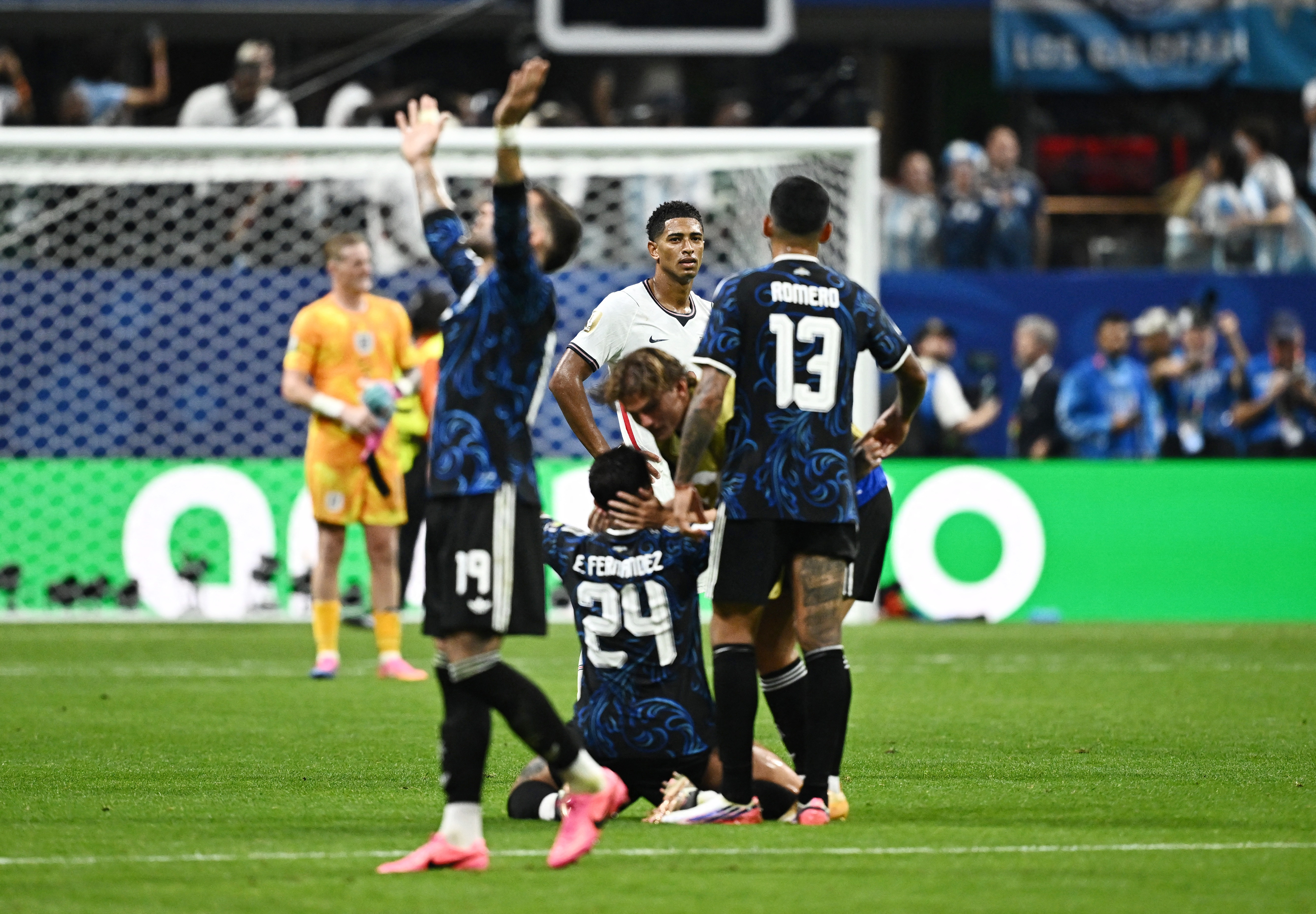 Soccer Football - FIFA World Cup 2026 - Semi Final - England v Argentina - Atlanta Stadium, Atlanta, Georgia, U.S. - July 15, 2026 Argentina's Enzo Fernandez, Cristian Romero and Nicolas Otamendi celebrate after the match as England's Jude Bellingham looks dejected REUTERS/Dylan Martinez