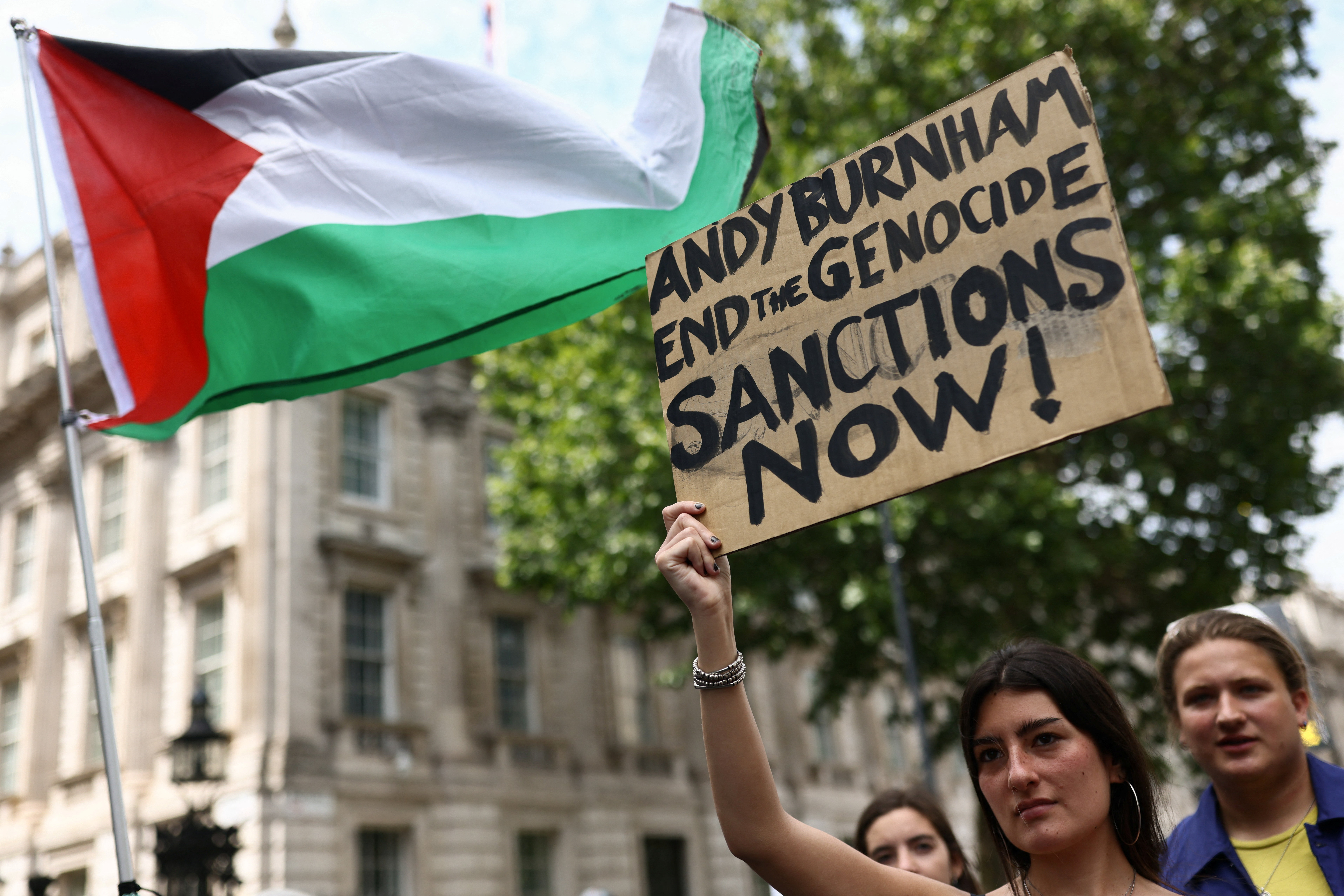 A woman holds a placard outside Downing Street during a "National March for Palestine" calling on Britain's next Prime Minister, Andy Burnham, to stand up for the Palestinian people, in London, Britain, July 18, 2026. REUTERS/Jack Taylor