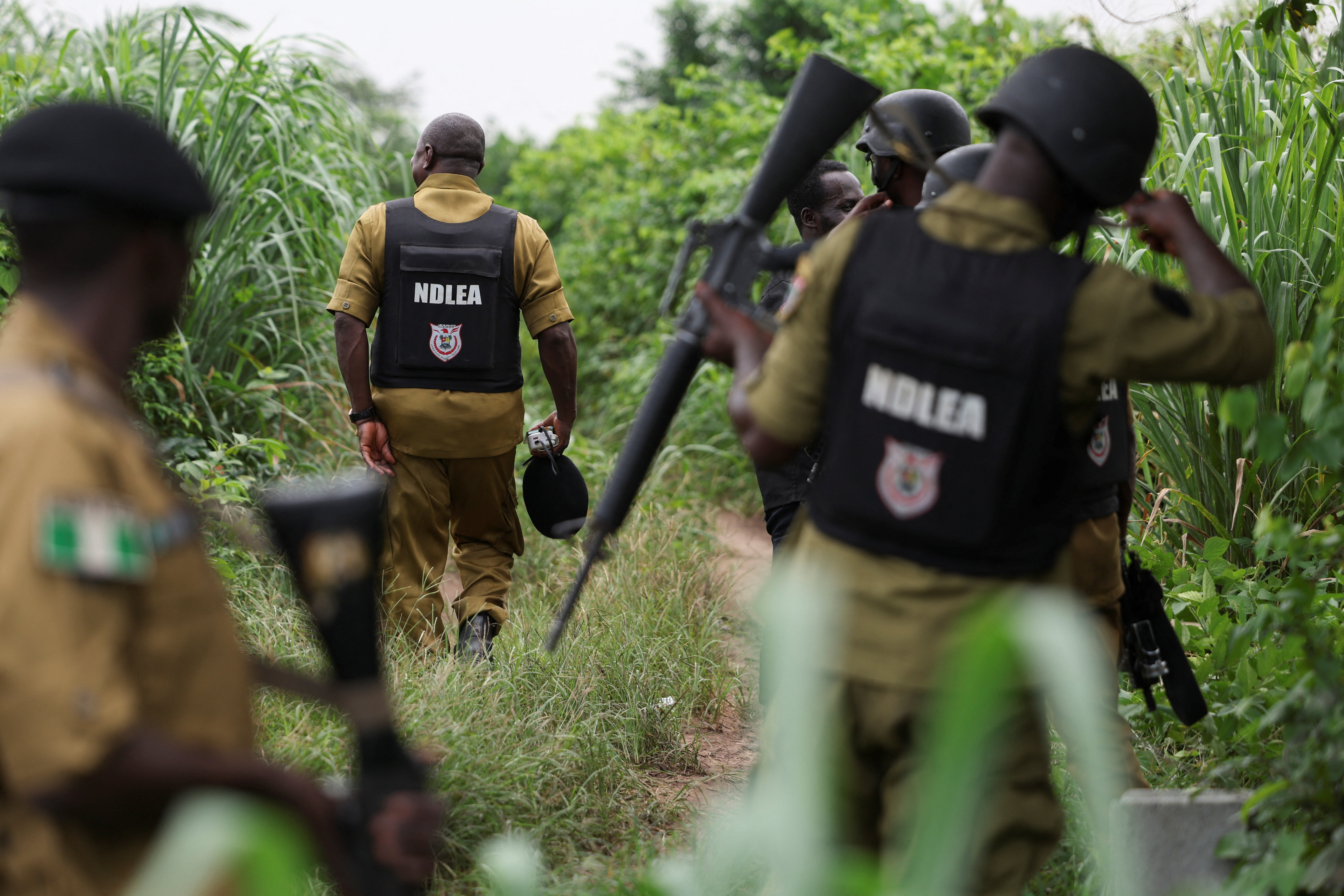 Law enforcement officers with the National Drug Law Enforcement Agency (NDLEA) inspects a site allegedly used by Mexican and Nigerian suspects as a clandestine methamphetamine laboratory, according to the NDLEA, during a visit to examine evidence in Ogun State, Nigeria, July 22, 2026. REUTERS/Sodiq Adelakun