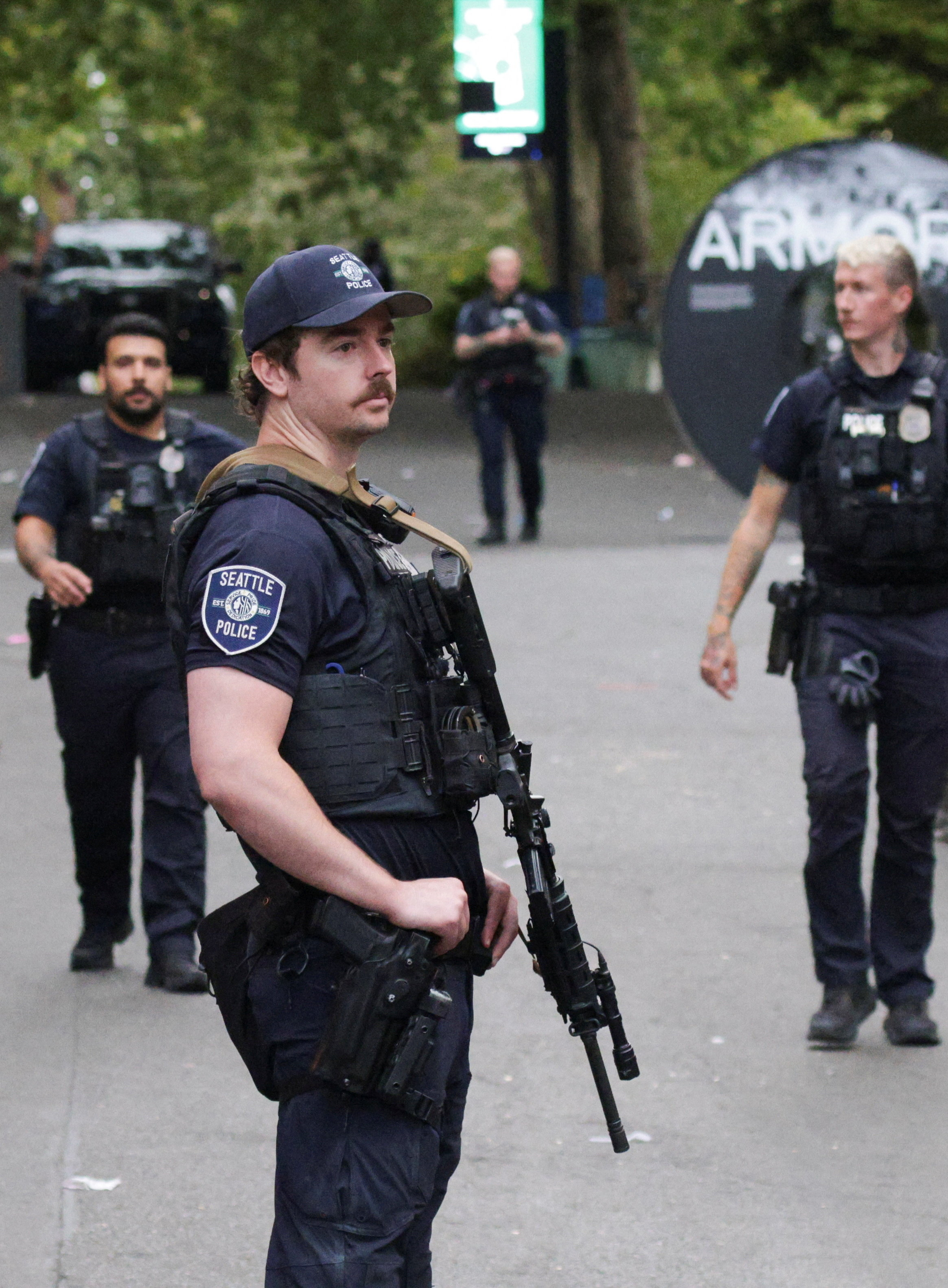 Police officers stand guard at a site after Seattle Police responded to what they described as a shooting with "multiple" victims at Seattle Center