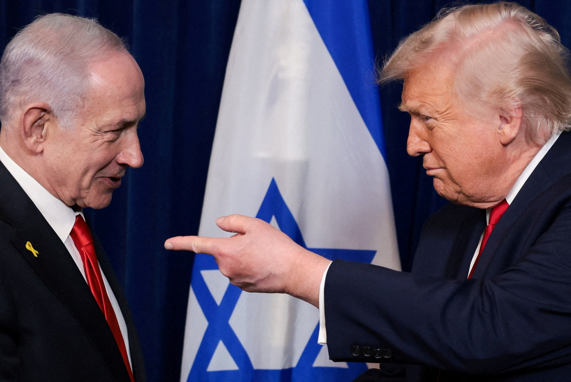 FILE PHOTO: U.S. President Donald Trump points his finger towards Israeli Prime Minister Benjamin Netanyahu during a press conference after meeting at Trump?s Mar-a-Lago club in Palm Beach, Florida, U.S., December 29, 2025. REUTERS/Jonathan Ernst/File Photo