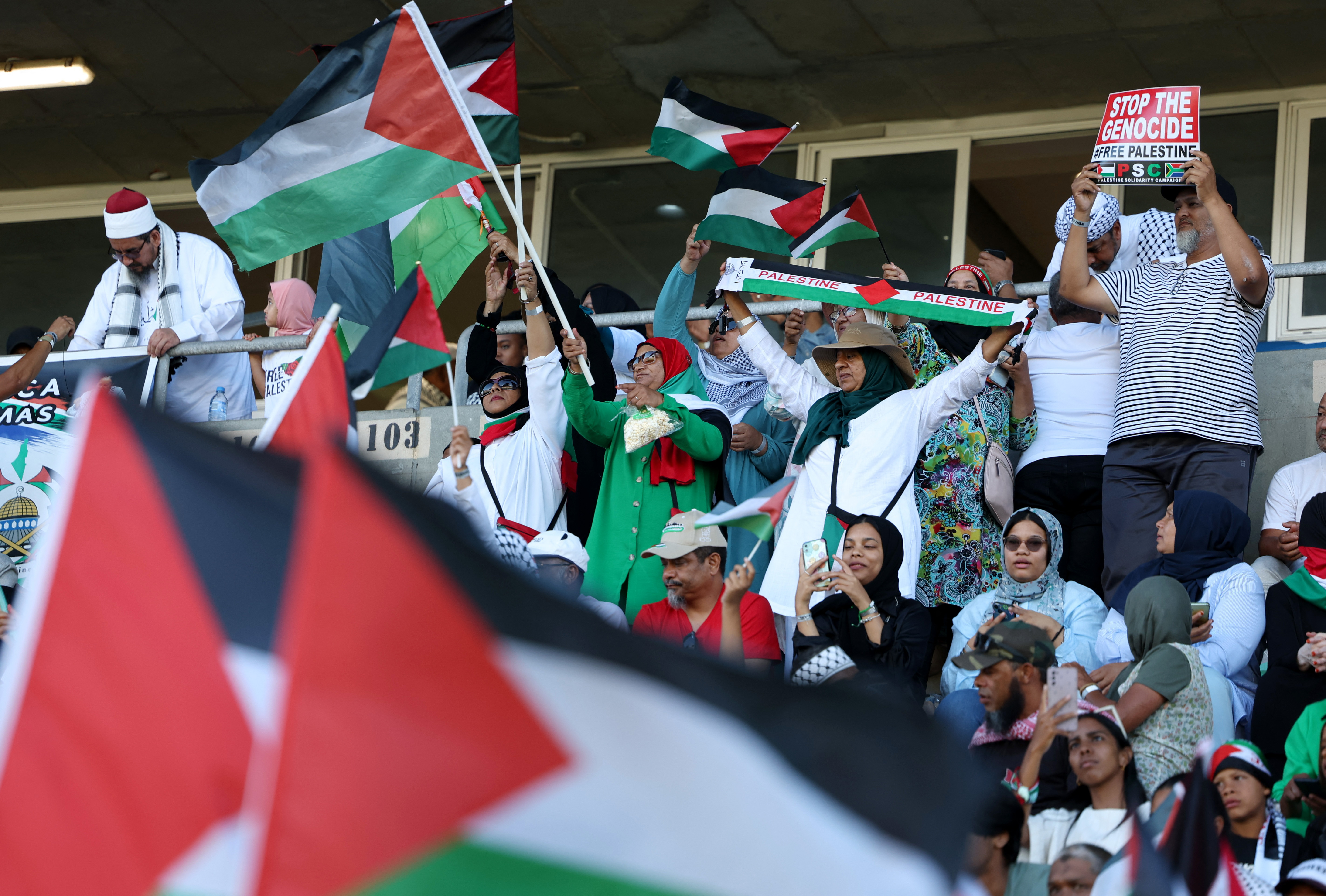 Soccer Football - South Africa Invitation XI v Palestine - Athlone Stadium, Cape Town, South Africa - February 18, 2024 Fans display flags in support of Palestine amid the ongoing conflict between Israel and Hamas REUTERS/Esa Alexander