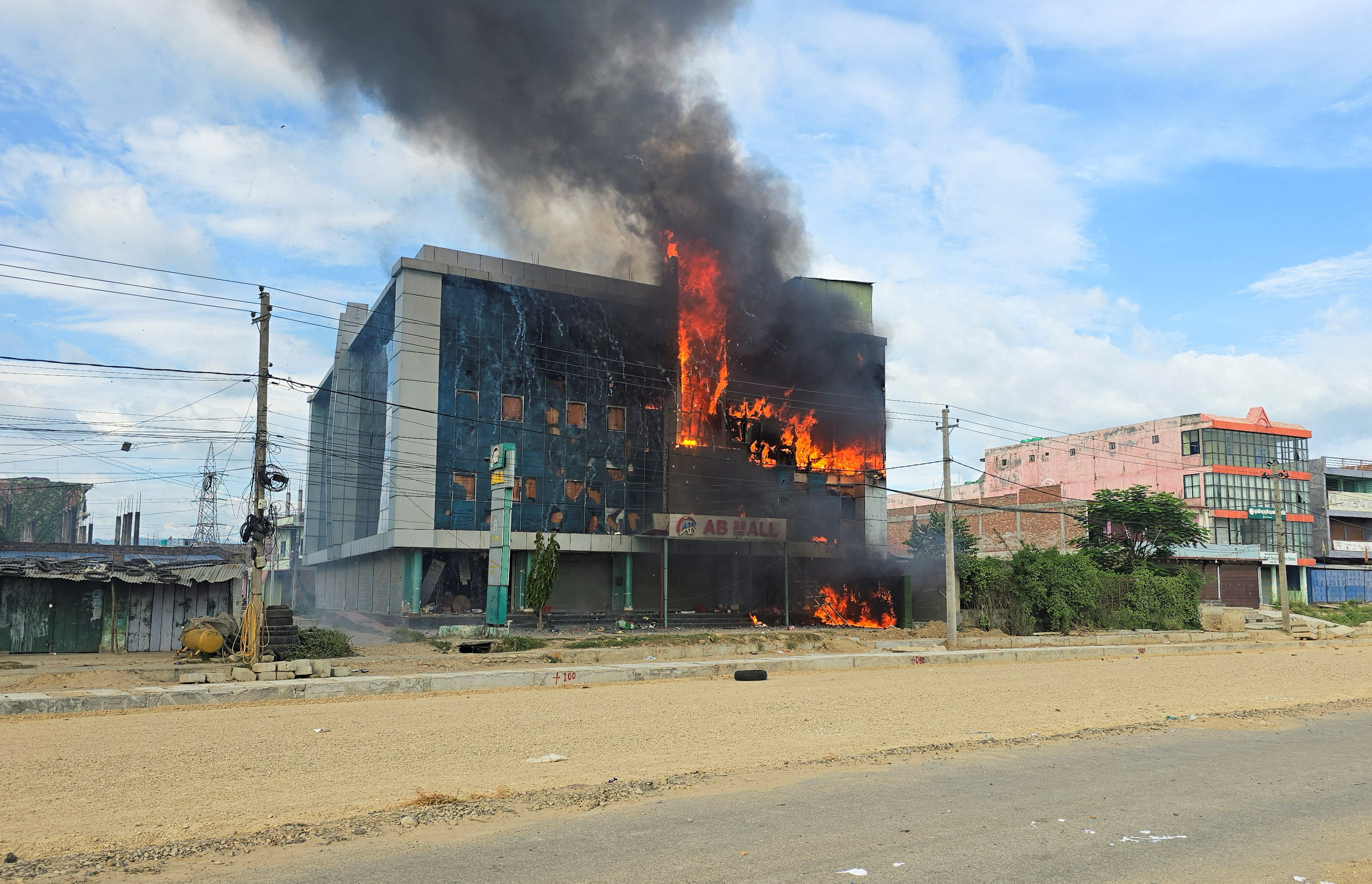 Smoke and fire rise from a mall after it was vandalised following a clash between two communities in Siraha, Nepal, July 30, 2026. Picture taken with a mobile phone. REUTERS/Stringer