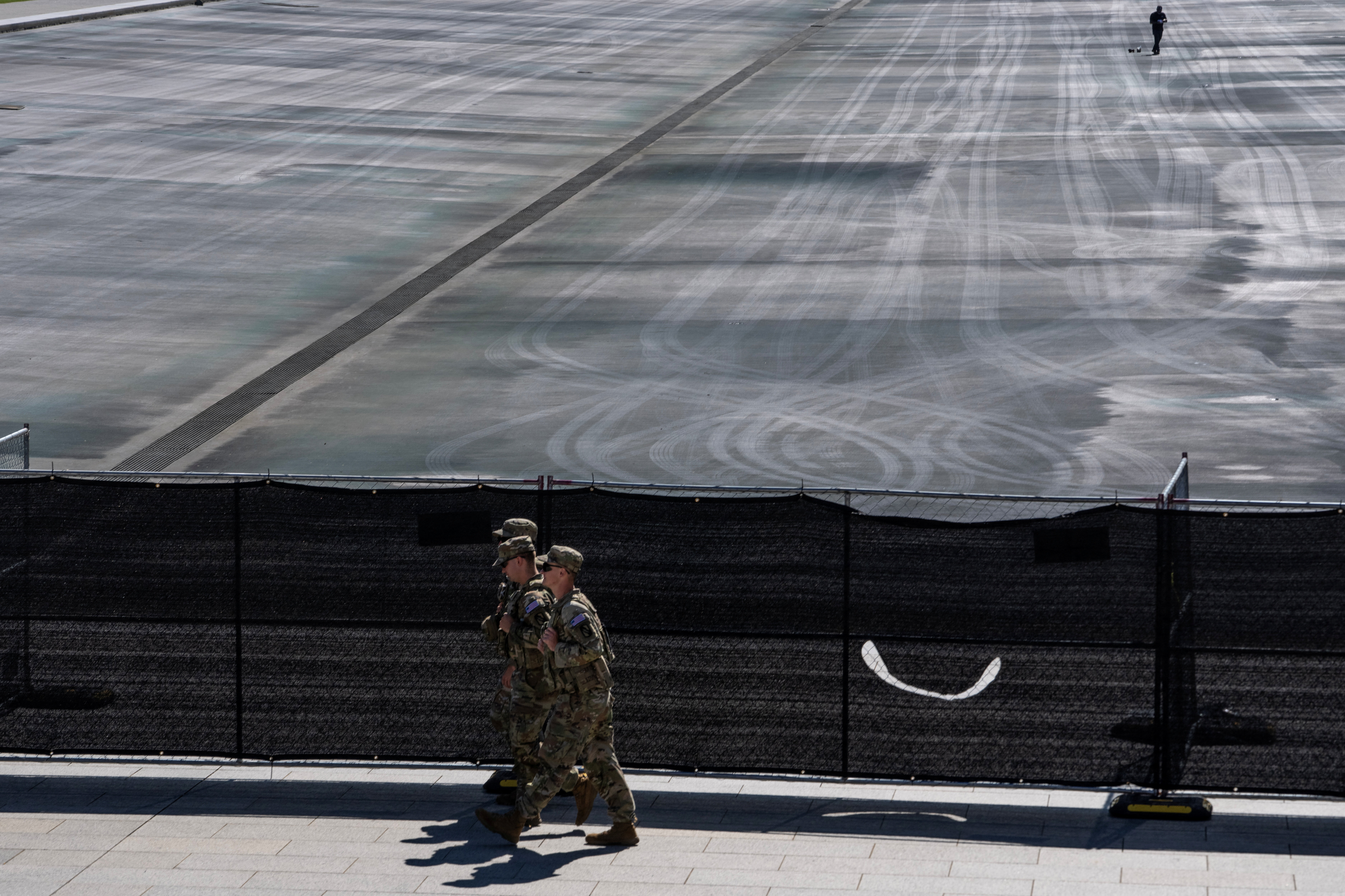 Members of the National Guard walk near fences at the drained Lincoln Memorial Reflecting Pool, following renovations and Independence Day celebrations, in Washington, D.C., U.S., July 30, 2026. REUTERS/Nathan Howard