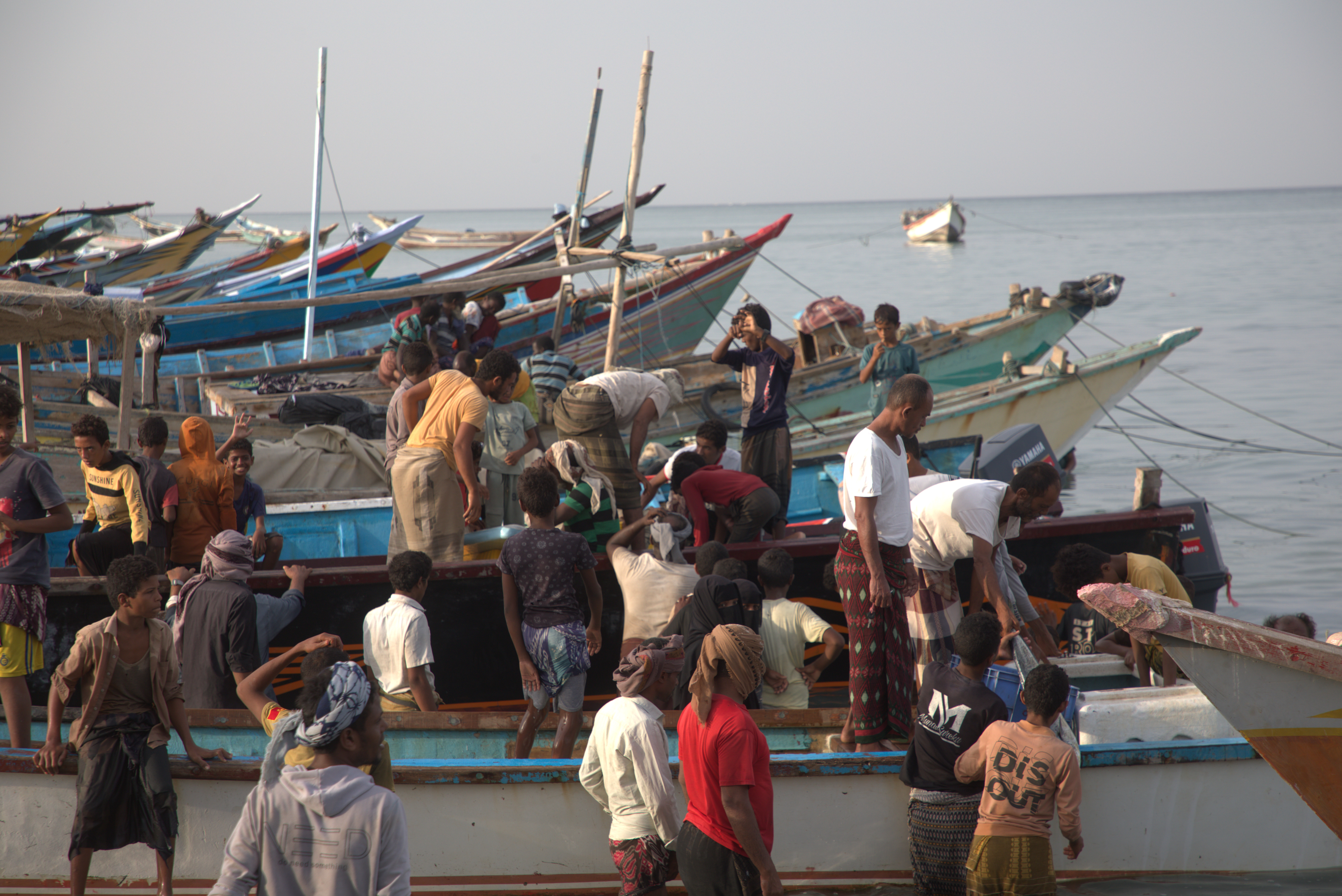 Fishermen around boats